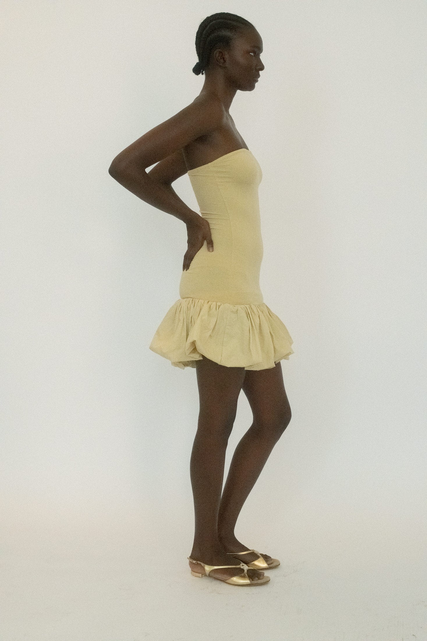 A dress that shifts between structure and release, unexpected and a little mischievous.