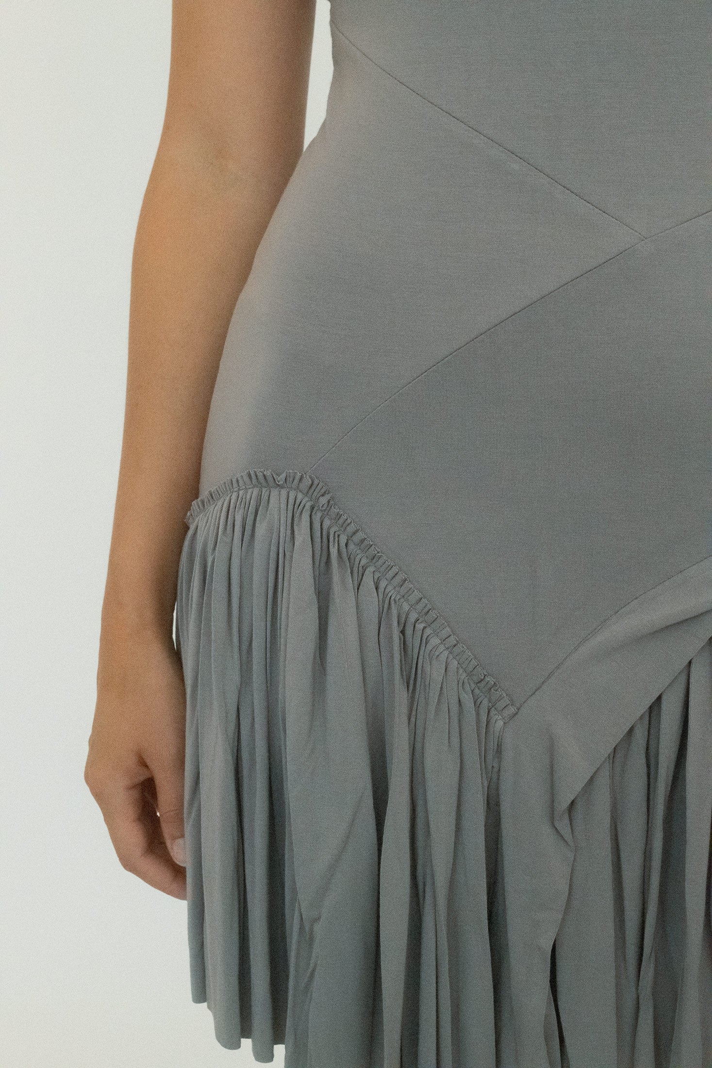 Crafted in soft jersey, it drapes close, hugging the body like a tight embrace.