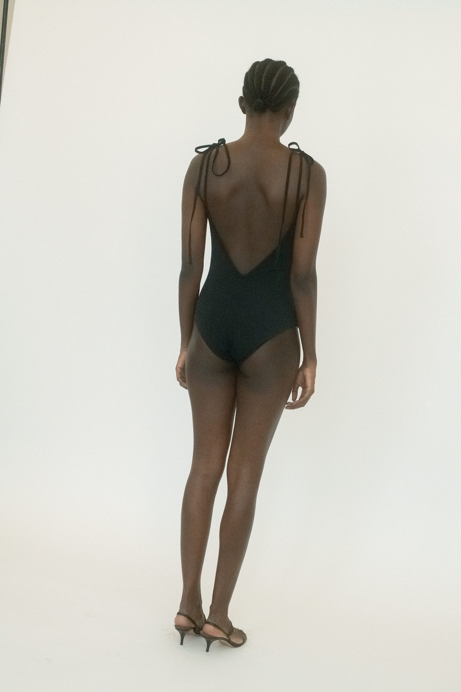Made in Bali, it’s rendered in supple swim fabric that clings in all the right places, turning a minimal silhouette into something quietly charged.