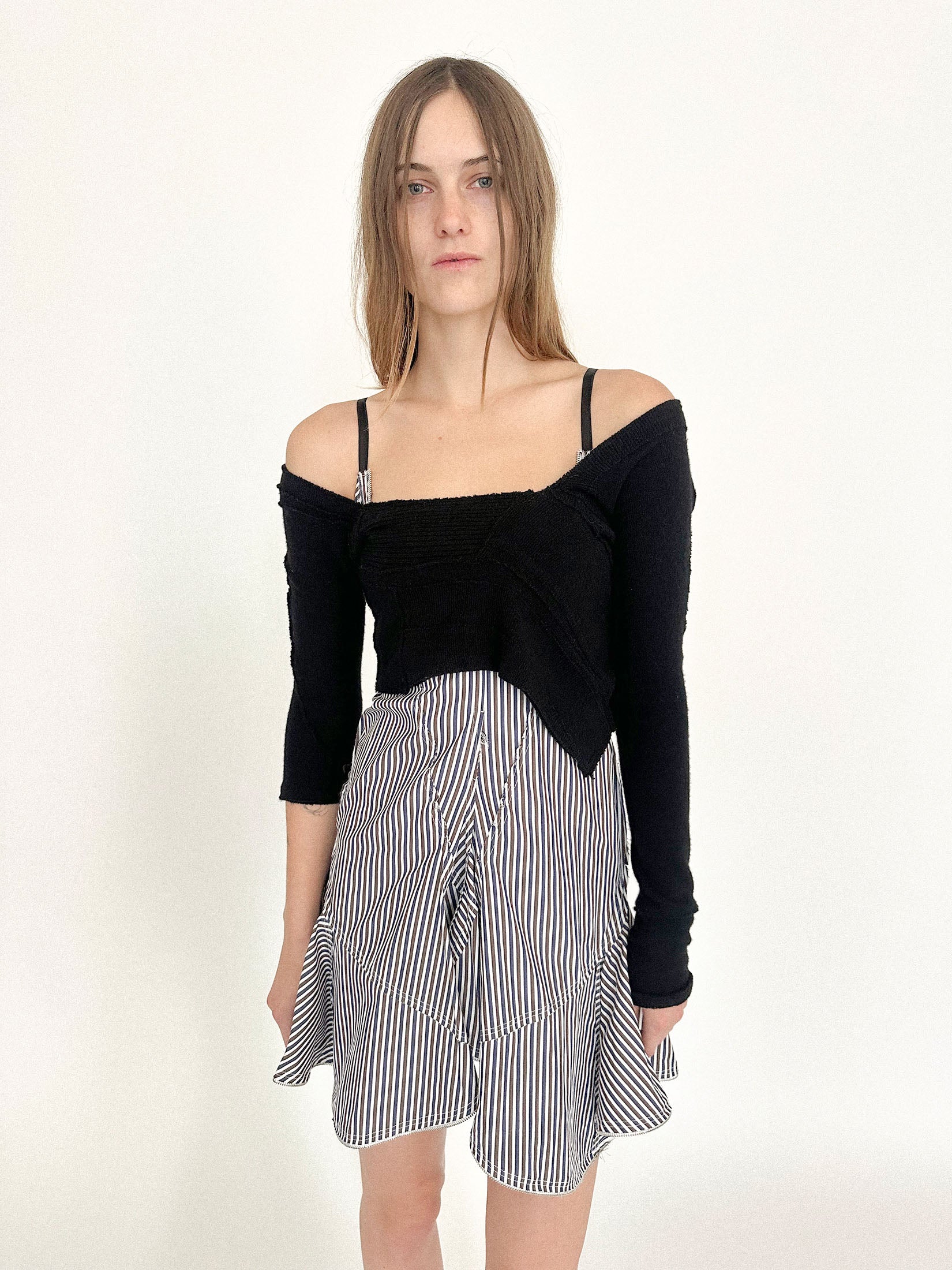 A cropped knit by Talia Byre, rendered in a dark noir that hides in the shadows.