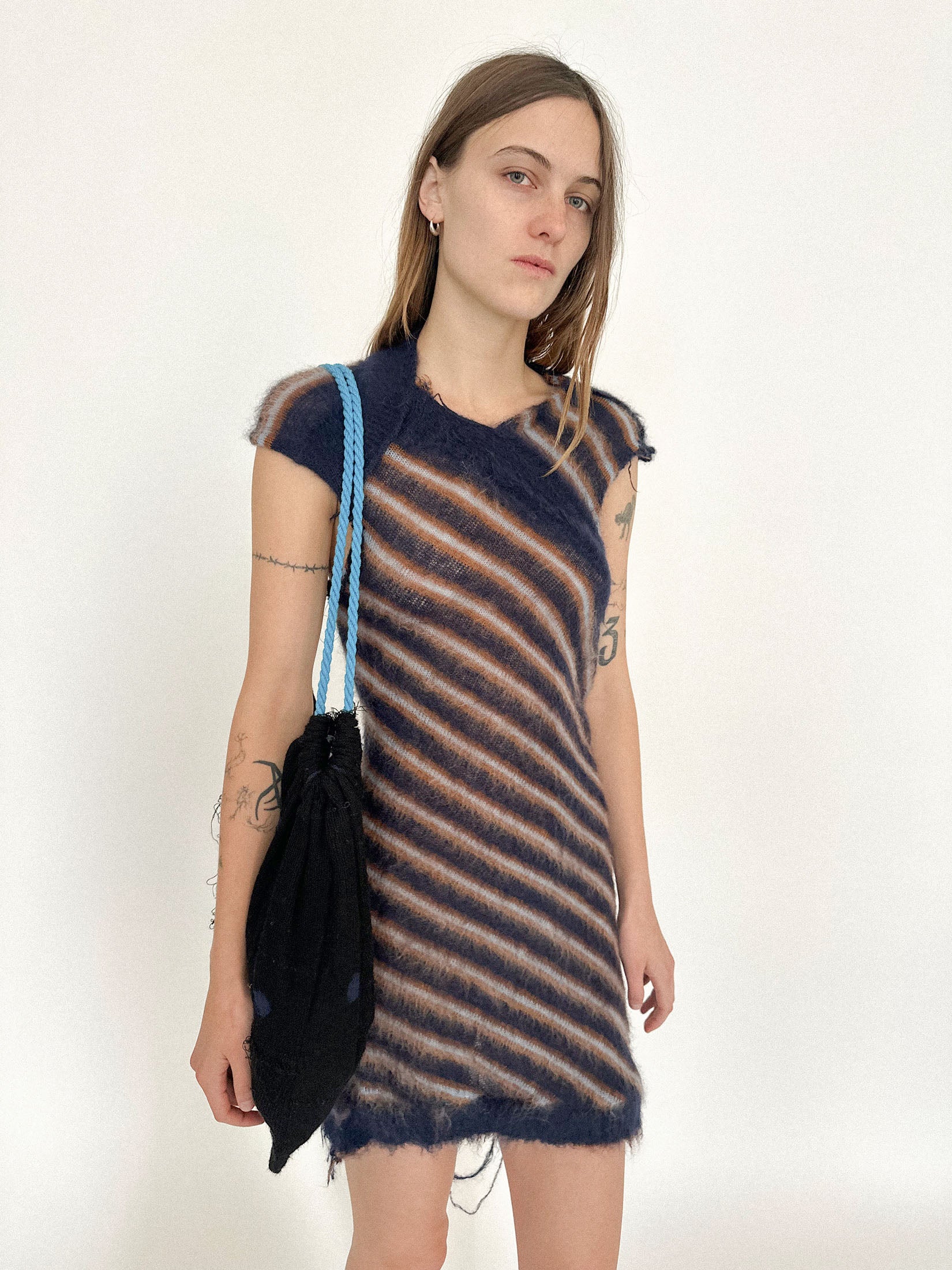 A knit drawstring bag by Talia Byre, a one-of-a-kind sample that blurs the line between utility and ornament.