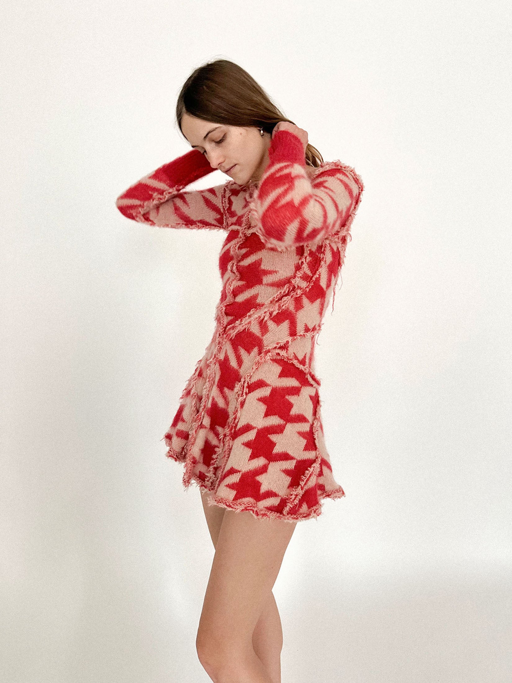 Ribbed cuffs and seams trace the frame with precision, a kind of soft armor disguised as knitwear.