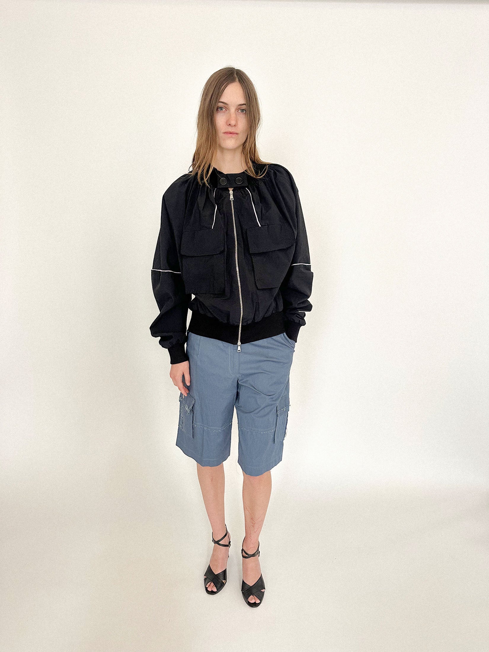 A bomber jacket by Talia Byre, inflated with quiet confidence and lilac-trimmed precision.
