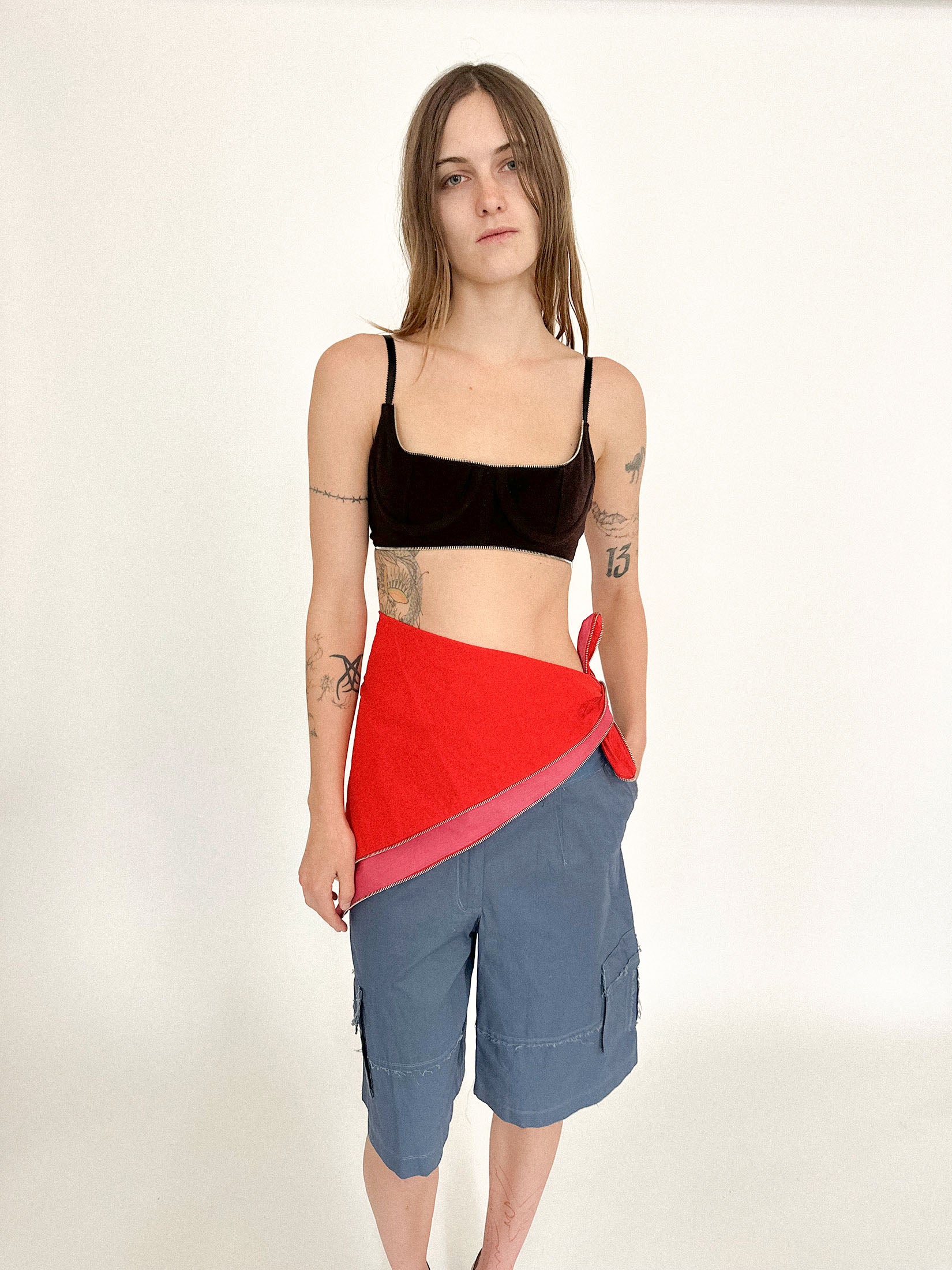 Red on the outside, pink within, it reveals its dual nature only in movement, a flash of contrast as it shifts against the skin.