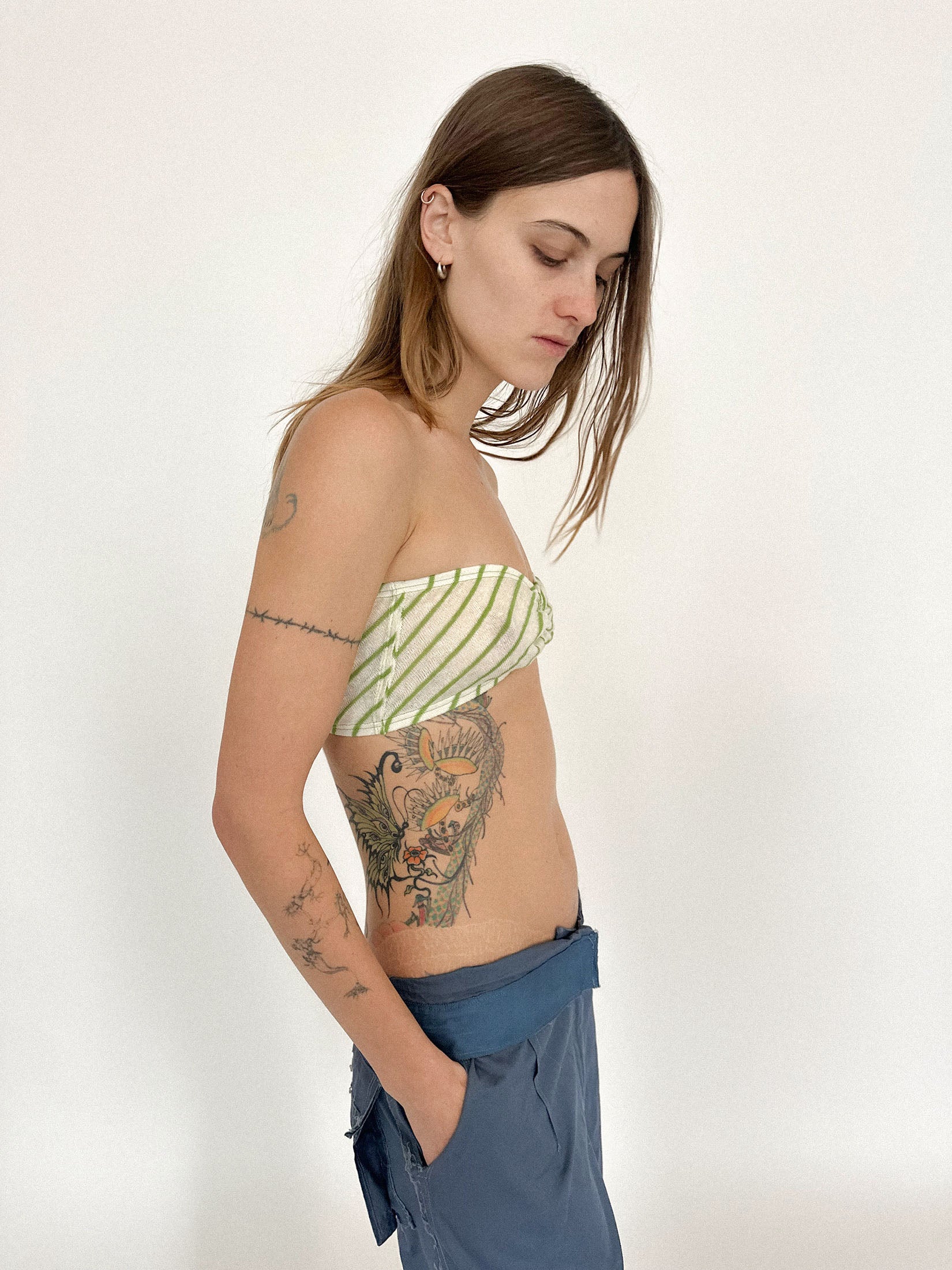 Green stripes coil and ripple across the body, drawing the eye in subtle, hypnotic motion.