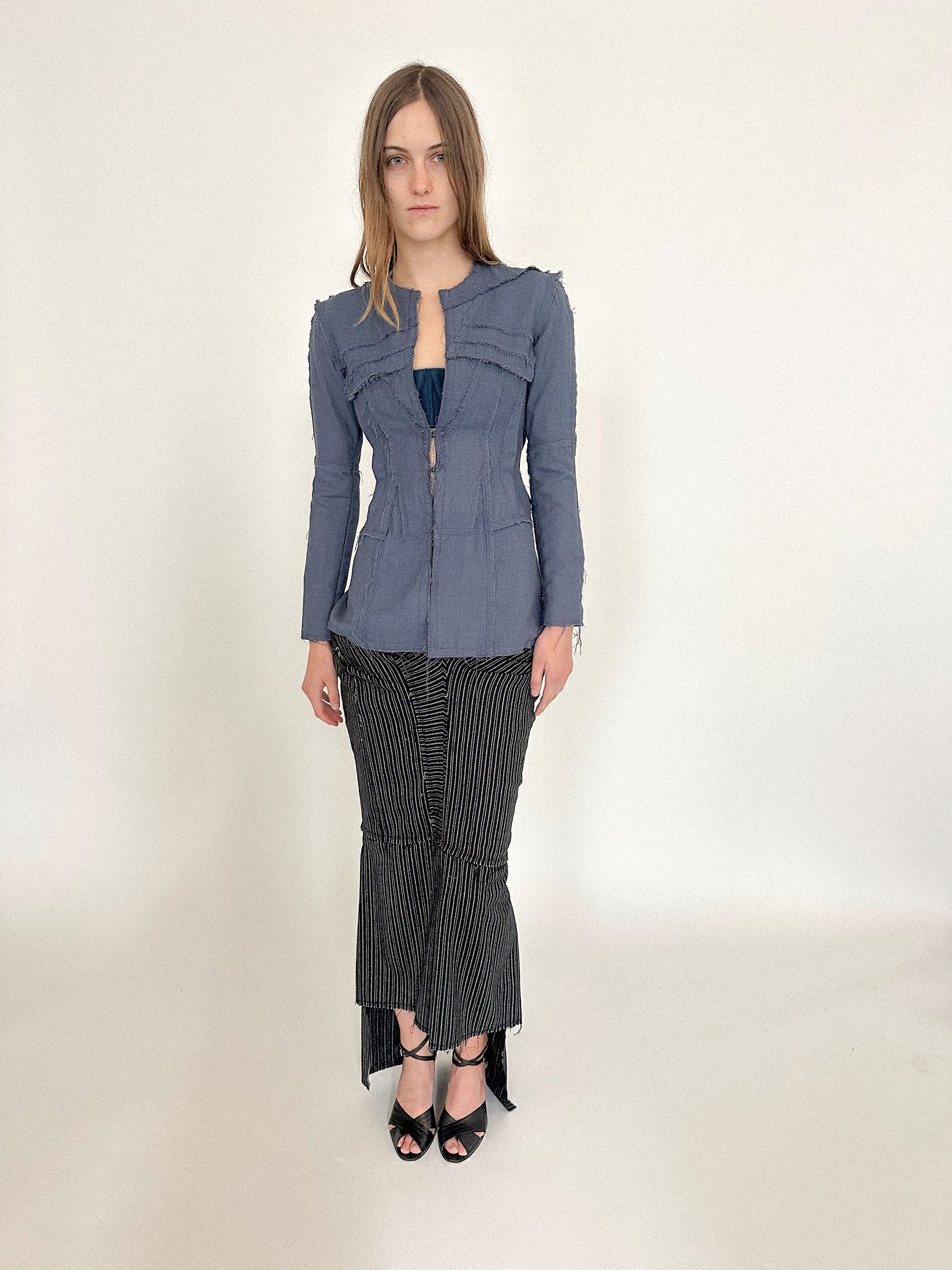 Exposed seams trace the body like deliberate handwriting: visible, intentional, and almost intimate in their precision.