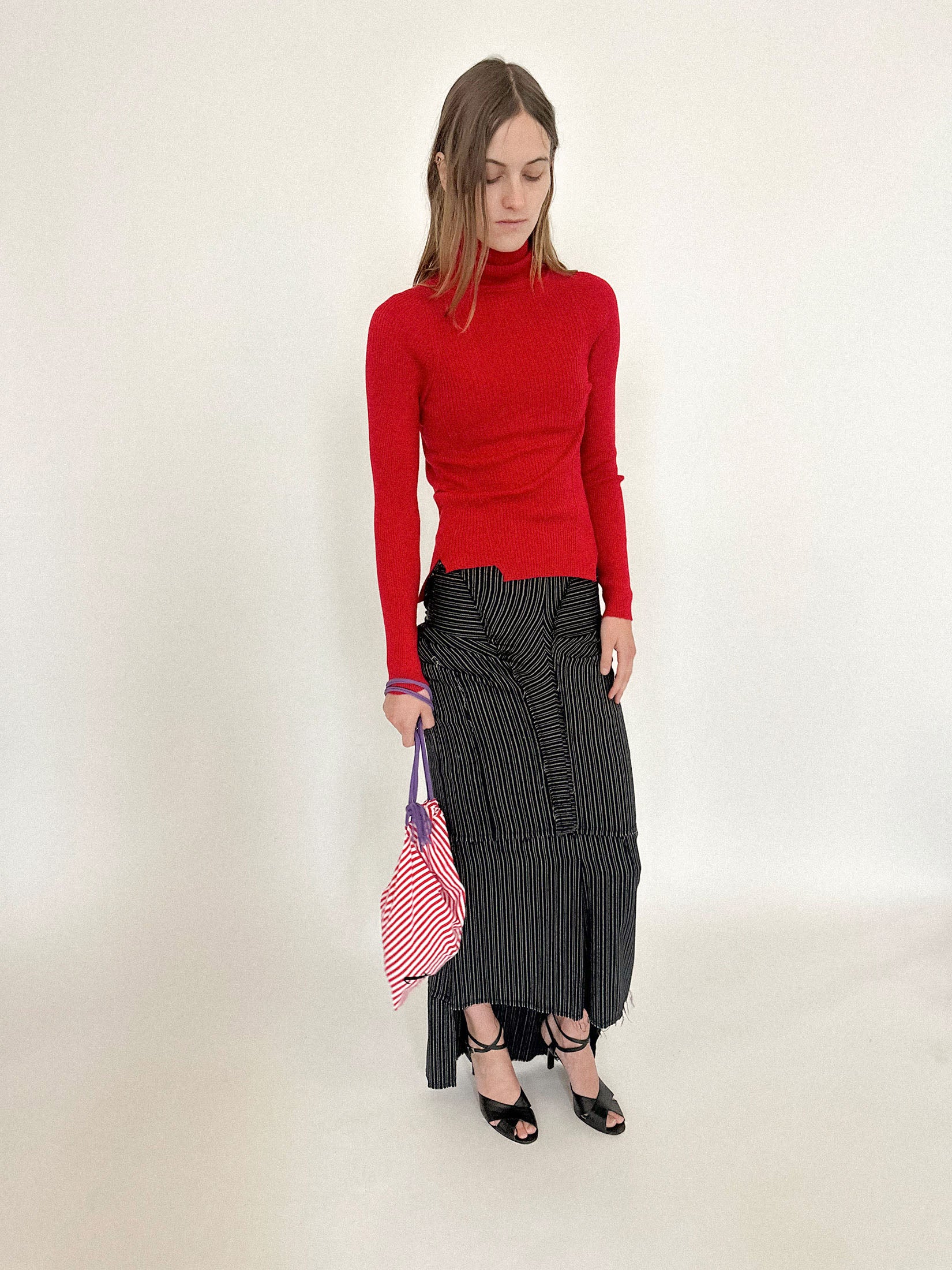 It can be worn crossbody or slung over the shoulder, casual but charged.