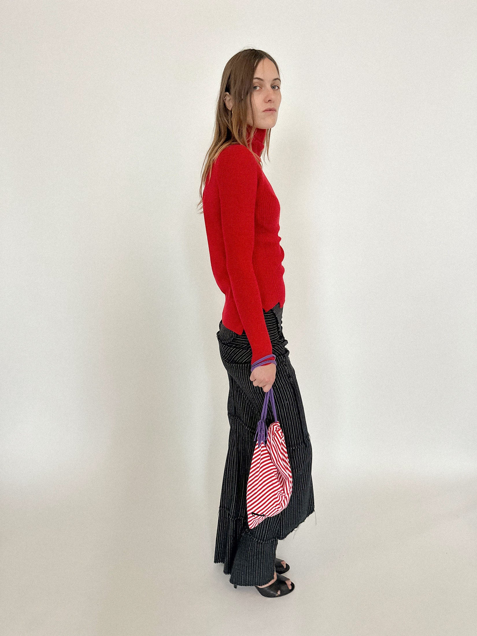 Candy cane striping wraps the body in rhythm, offset by rich purple straps that bring contrast.