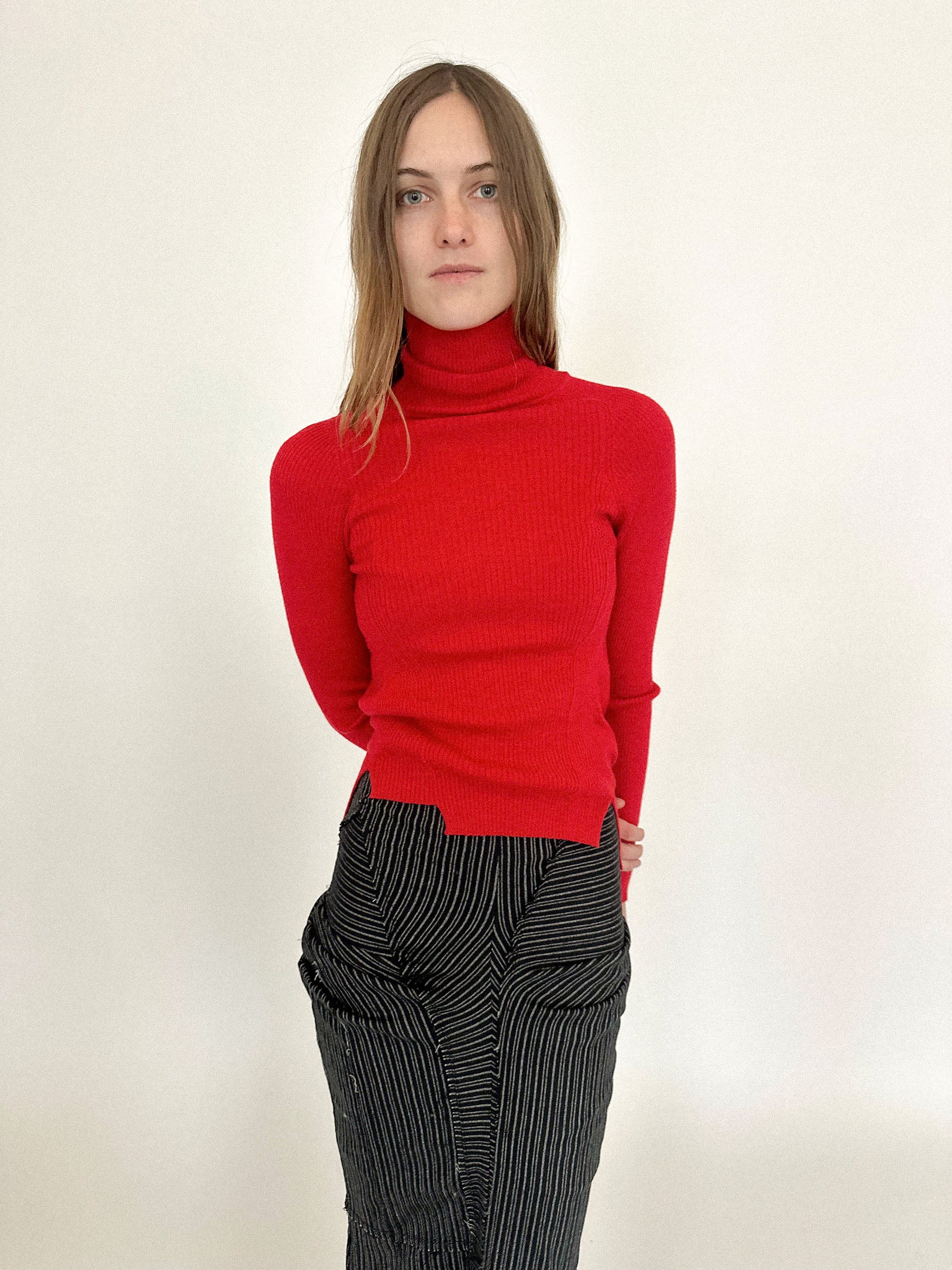 The fit is tight, like a second-skin, while a slight asymmetry at the hem throws the perfection just off balance.