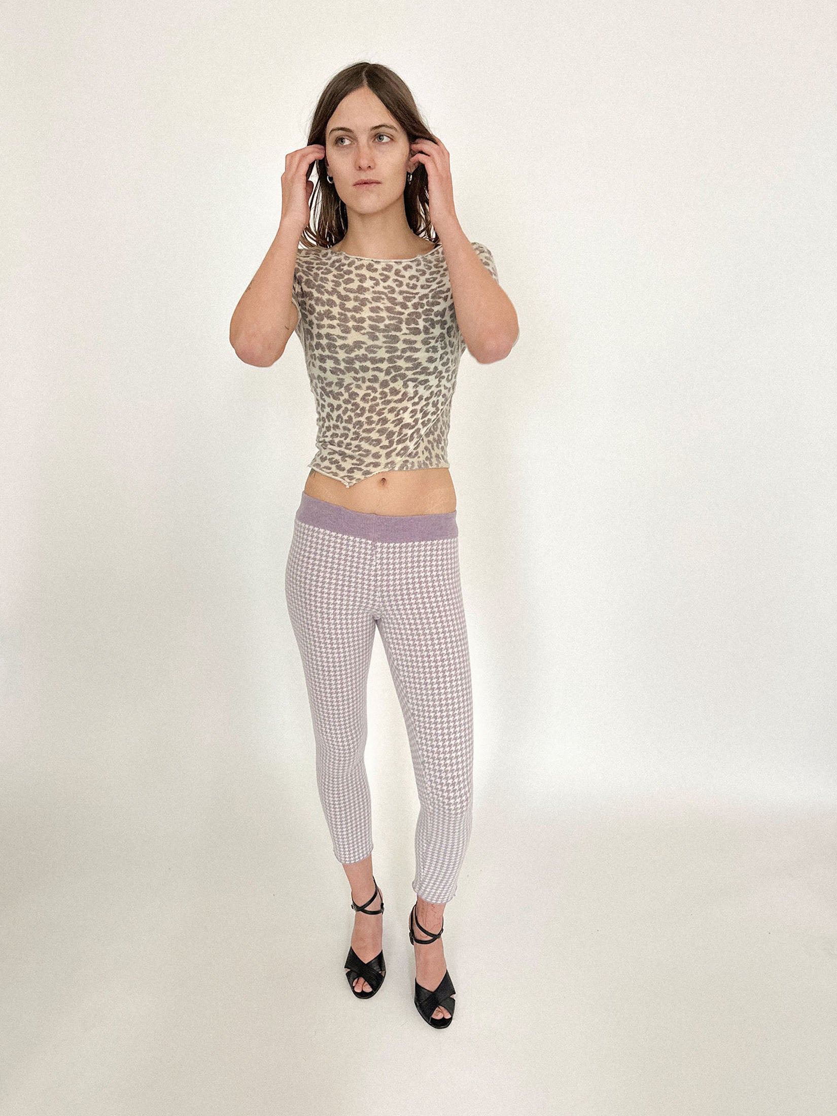 High-waisted knit leggings by Talia Byre, rendered in a lilac houndstooth that feels both precise and a little unruly.