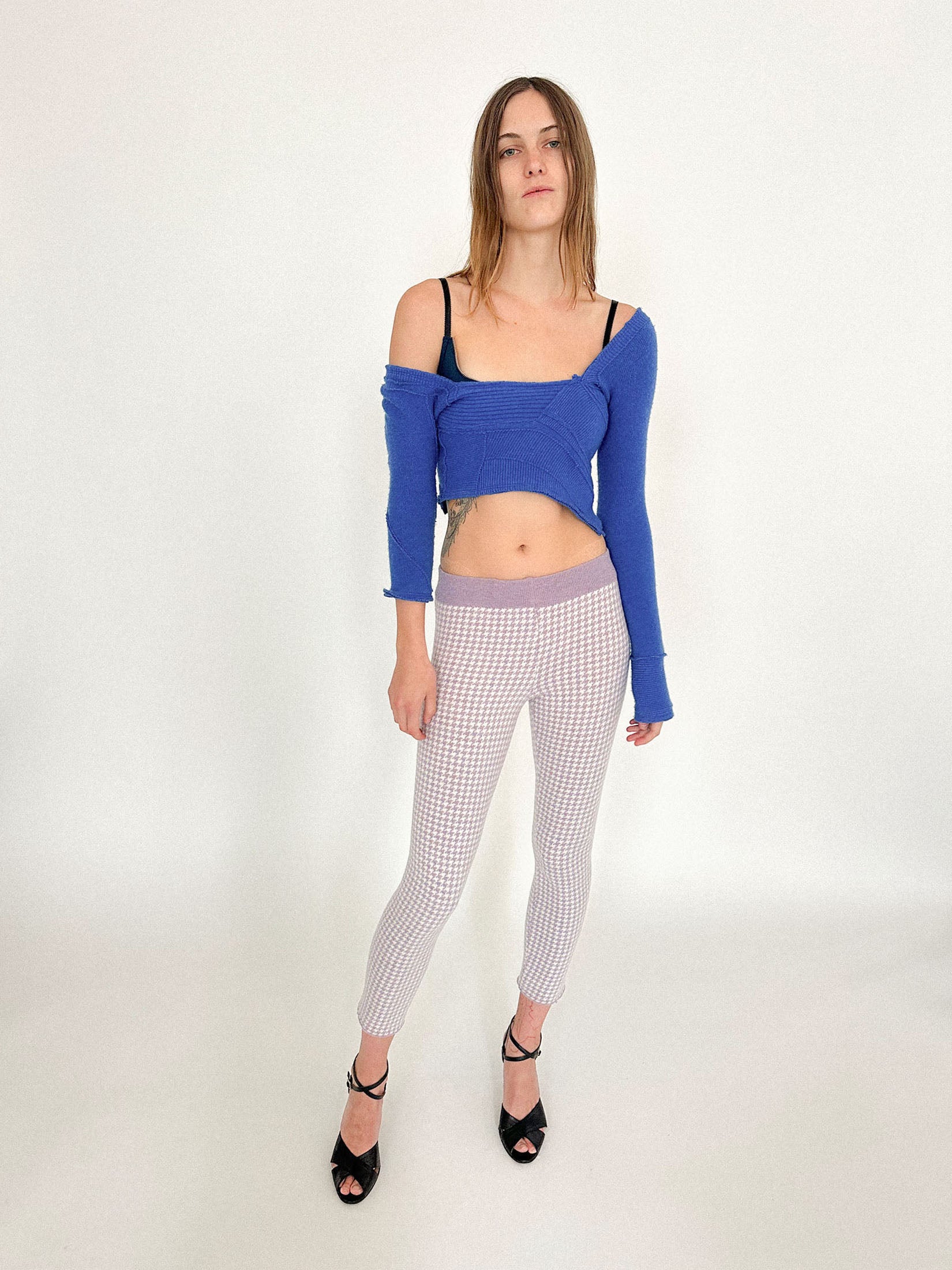 The asymmetrical sleeves shift the balance, creating a rhythm that feels both off-kilter and intentional.