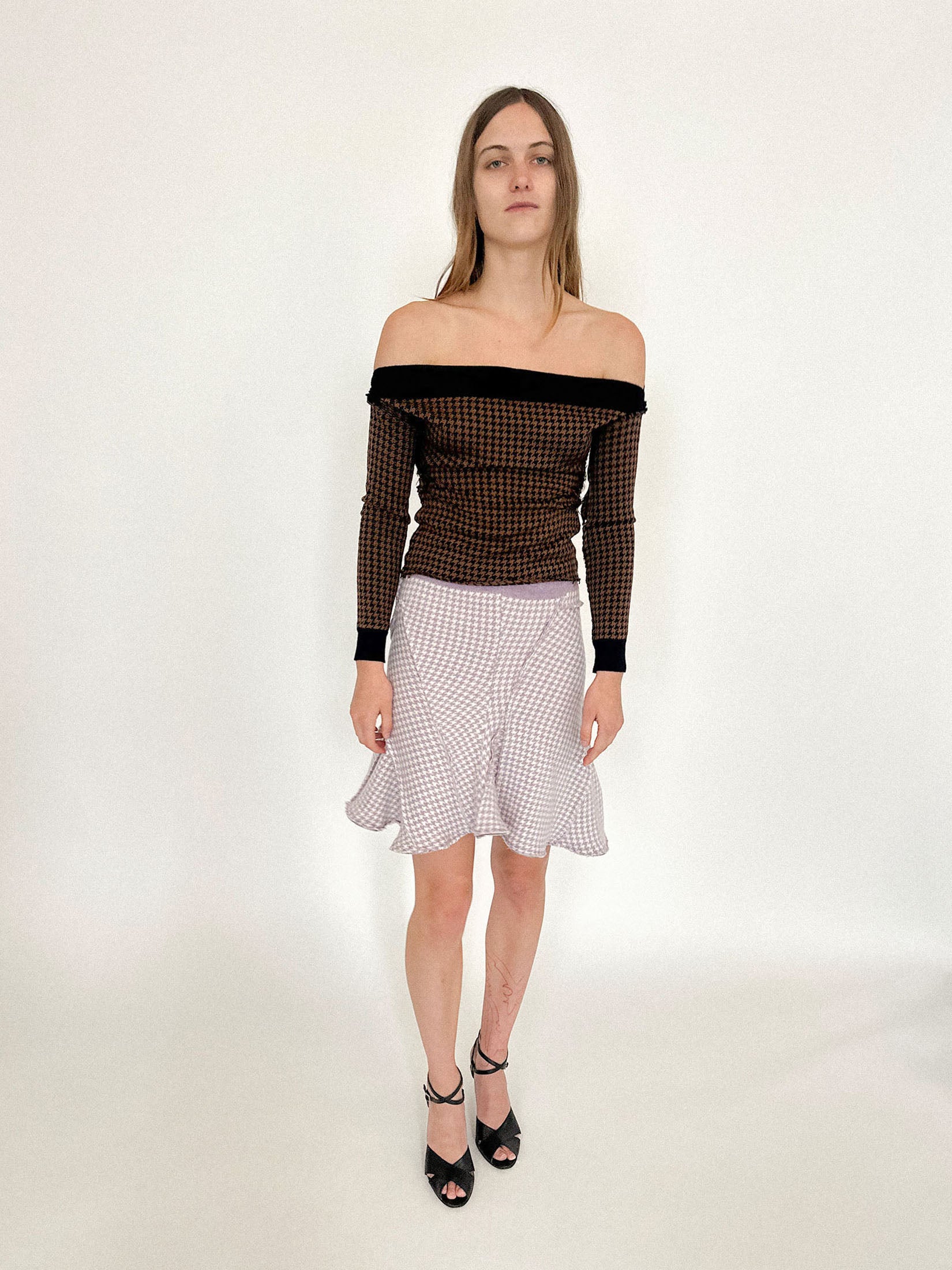 A high-waisted knit skirt by Talia Byre, patterned in classic houndstooth and cut with an offbeat ease.