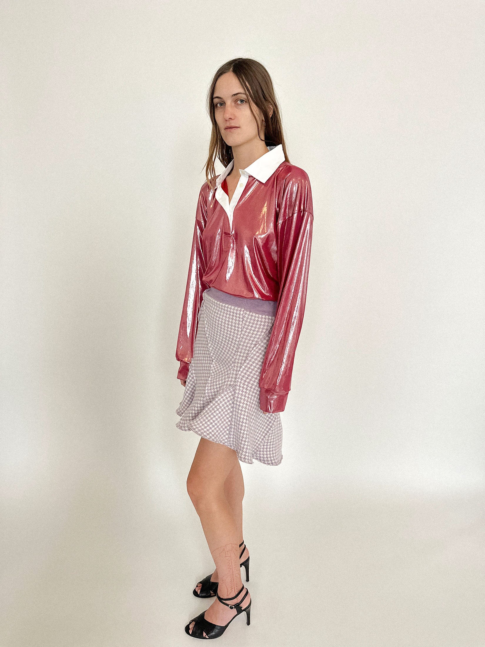 The white poplin collar keeps it grounded - preppy on the surface, dangerous underneath.