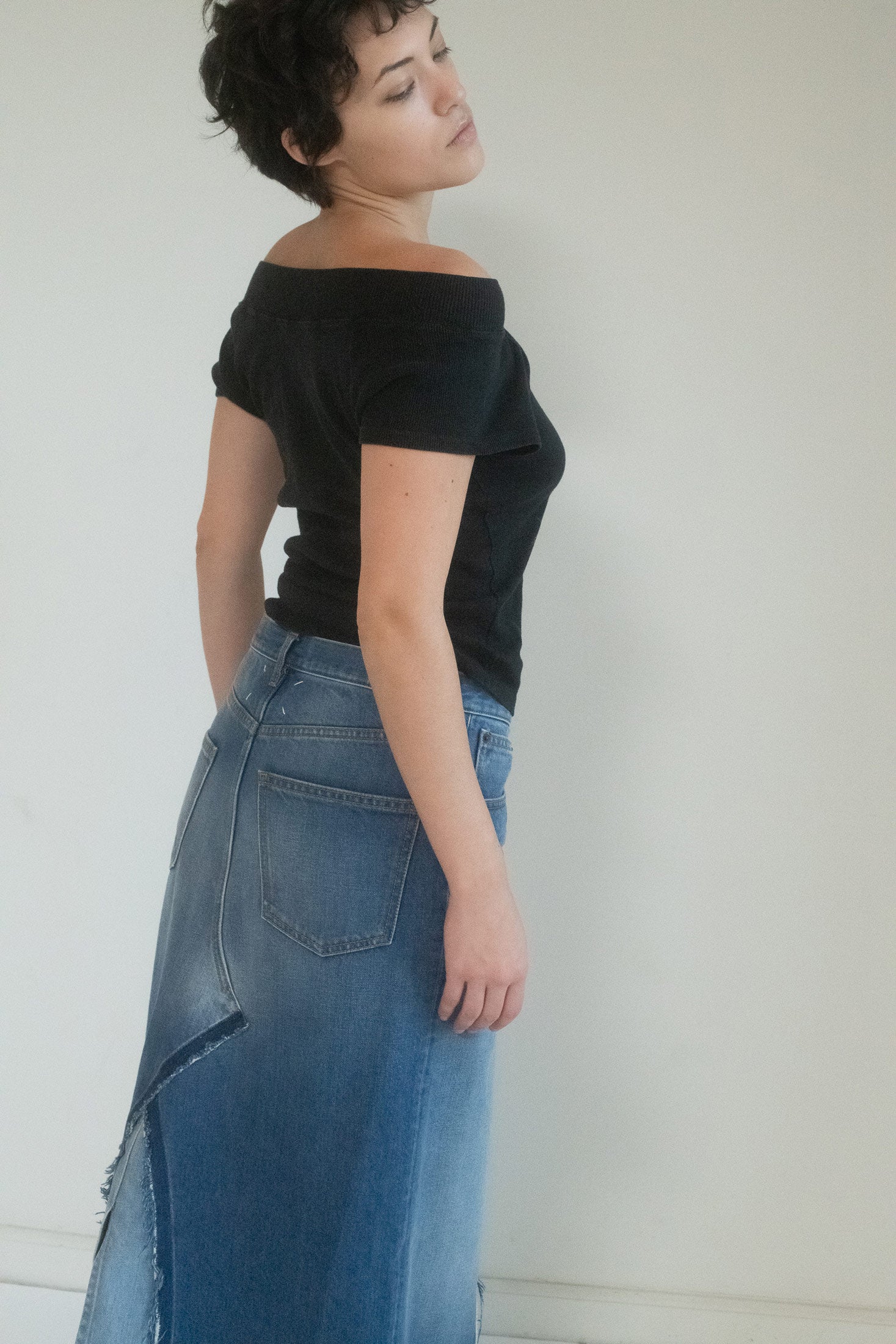 The floor-length silhouette is unexpected, dramatic, a modern reinvention of the classic denim skirt, wrapped in the kind of timeless elegance that turns heads without effort.