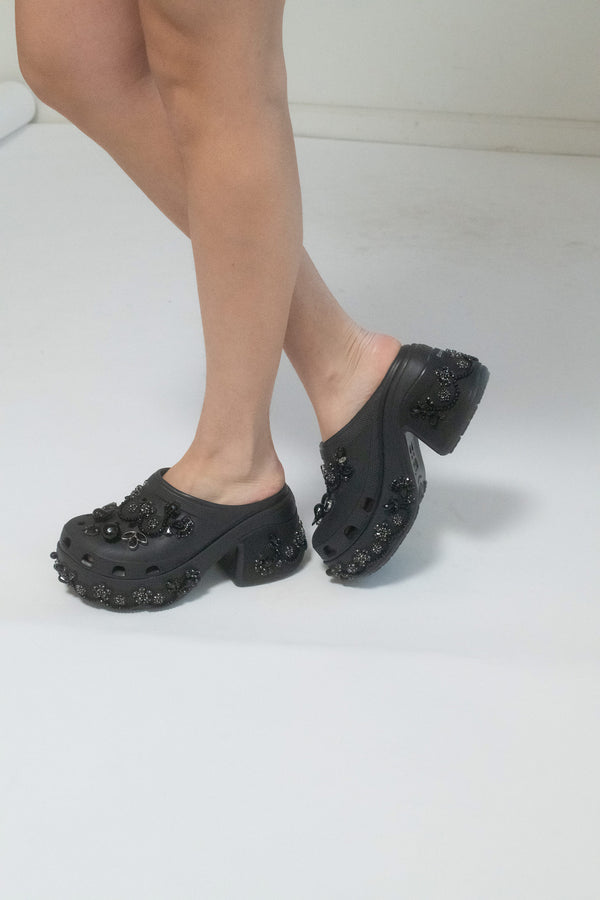 From Chloë Sevigny’s personal archive, the Simone Rocha x Crocs platform mules—a paradox of comfort and couture. 