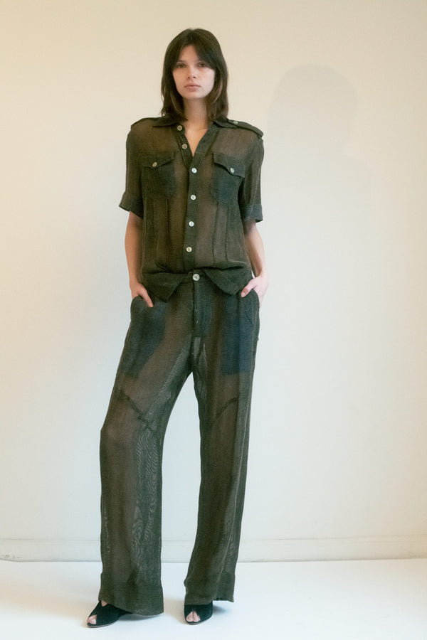 Linder’s mid-waisted trousers embody the quiet power of contrast—effortlessly balancing the crisp, structured lines of a classic silhouette with the undeniable intrigue of sheer fabric. 