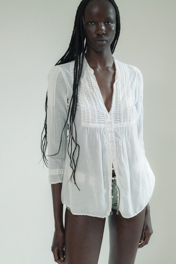 The Vintage Semi-Sheer Button Down in soft white is the kind of piece that lingers—lightweight, effortless, and laced with suggestion.