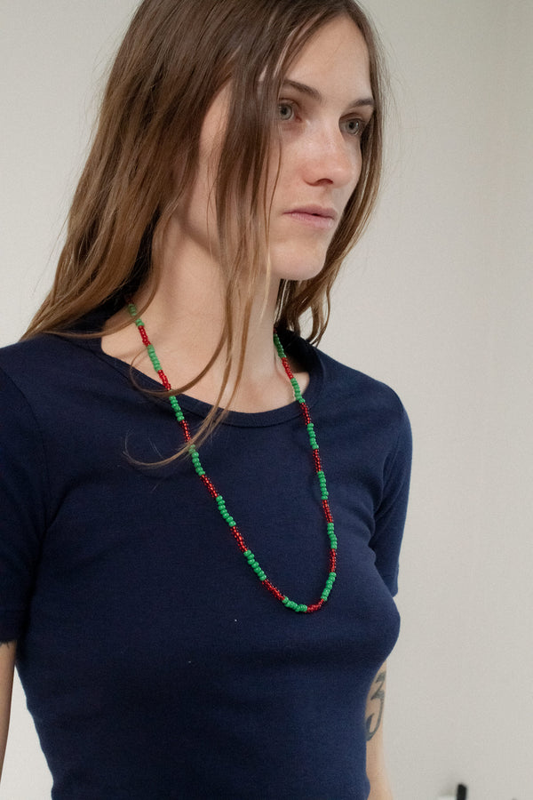 Unveil the timeless beauty of the Vintage Beaded Necklace, a stunning accessory that blends vibrant red and green beads with subtle elegance. 