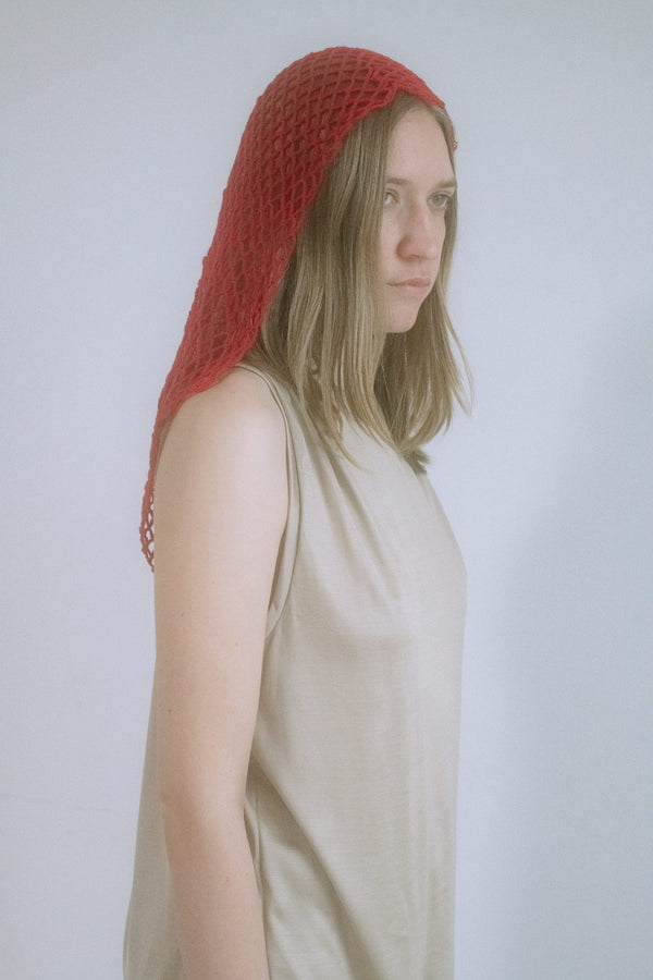 A head-turner in every sense, this knitted net hood from Judy Turner wraps the head like a whispered secret.
