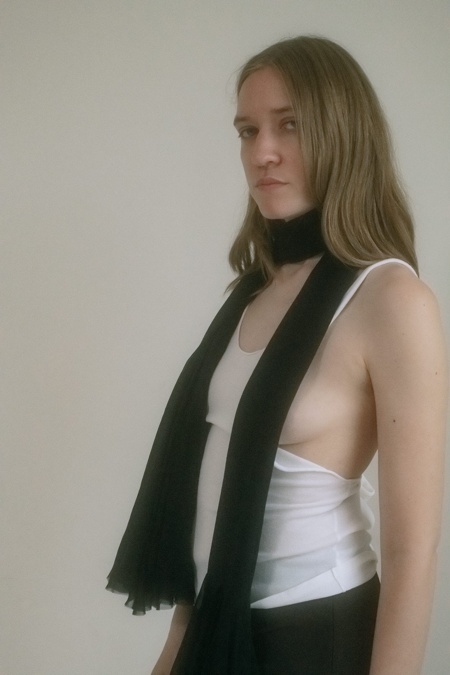 This long crochet scarf, midnight black and hand-spun in New York, features sculptural bell flower flares at each end, dramatic and strange.