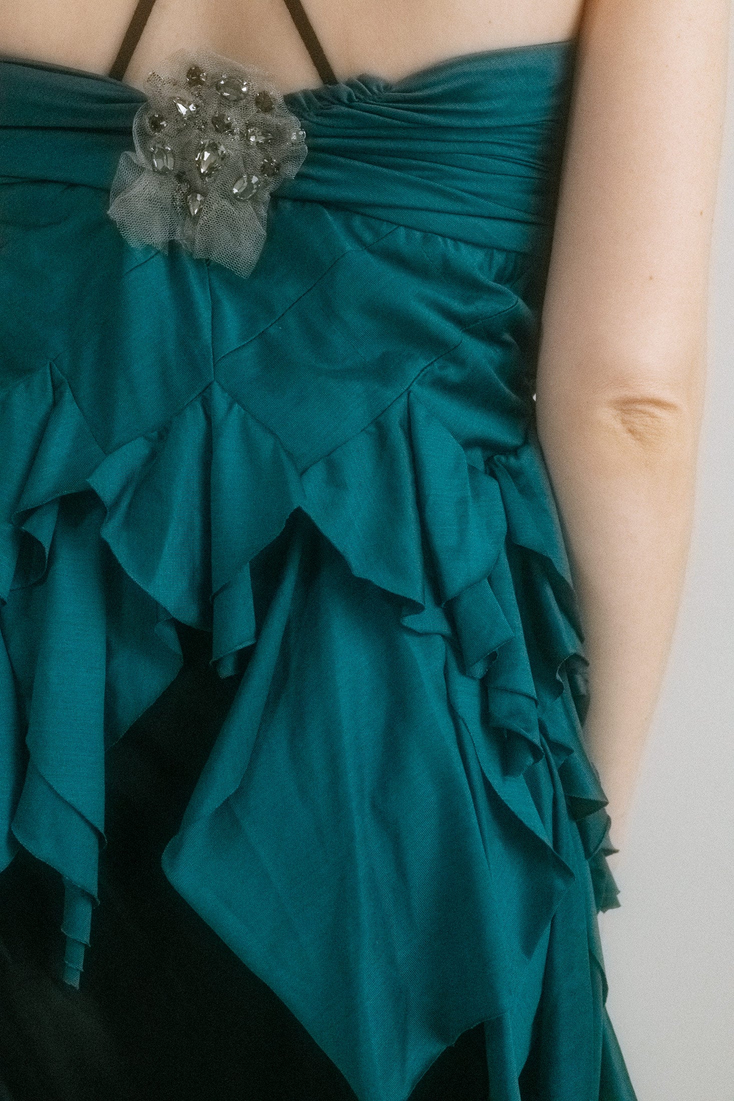 This teal piece shimmers with a subtle sheen, blurring the lines between top and skirt. 
