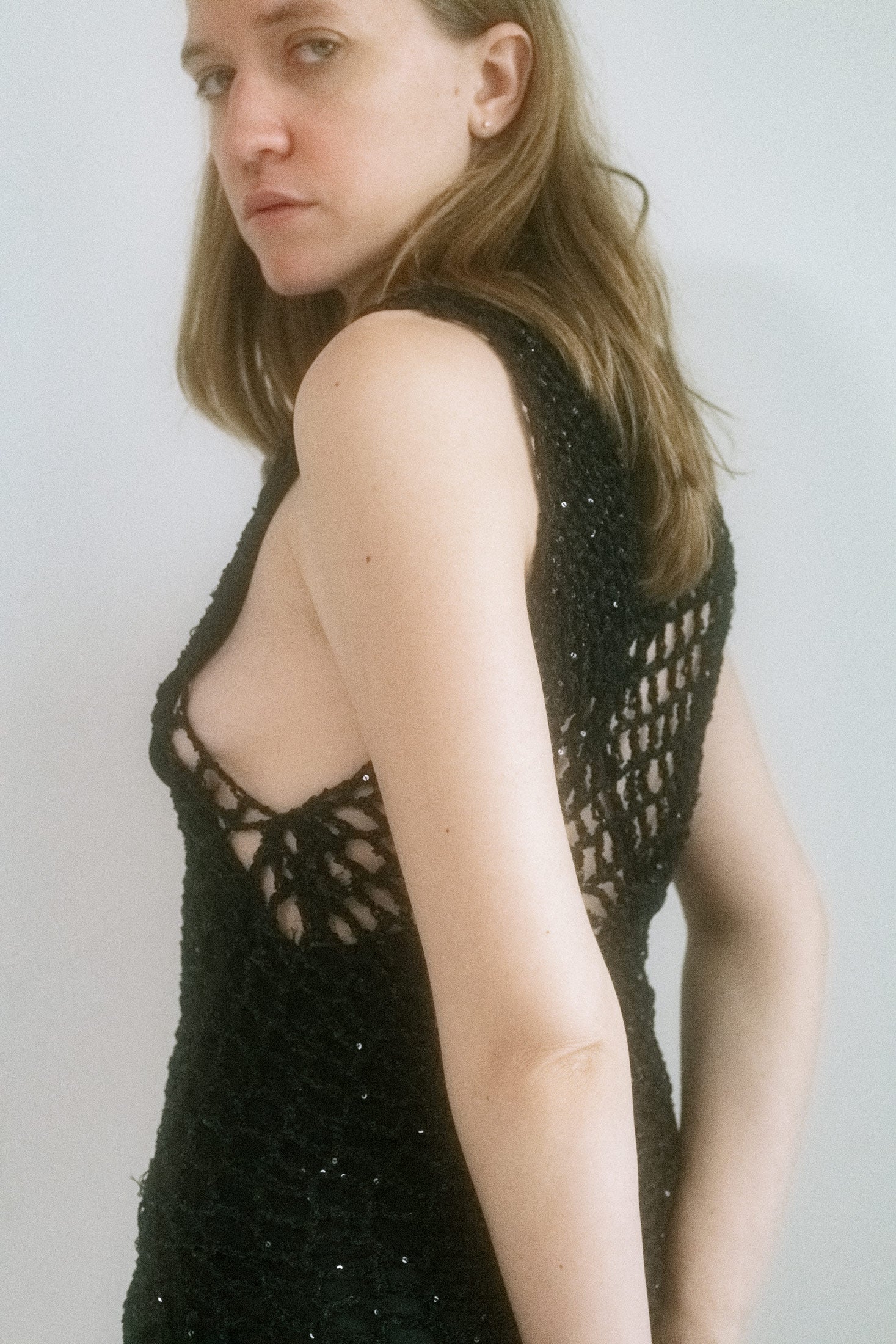From Judy Turner’s New York studio, a high-neck crochet tunic spun with the precision of a spider in seduction mode. 
