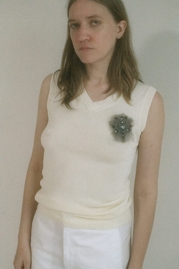 From Judy Turner’s New York studio, this sleeveless V-neck sweater vest is a delicate whisper of cool allure. 
