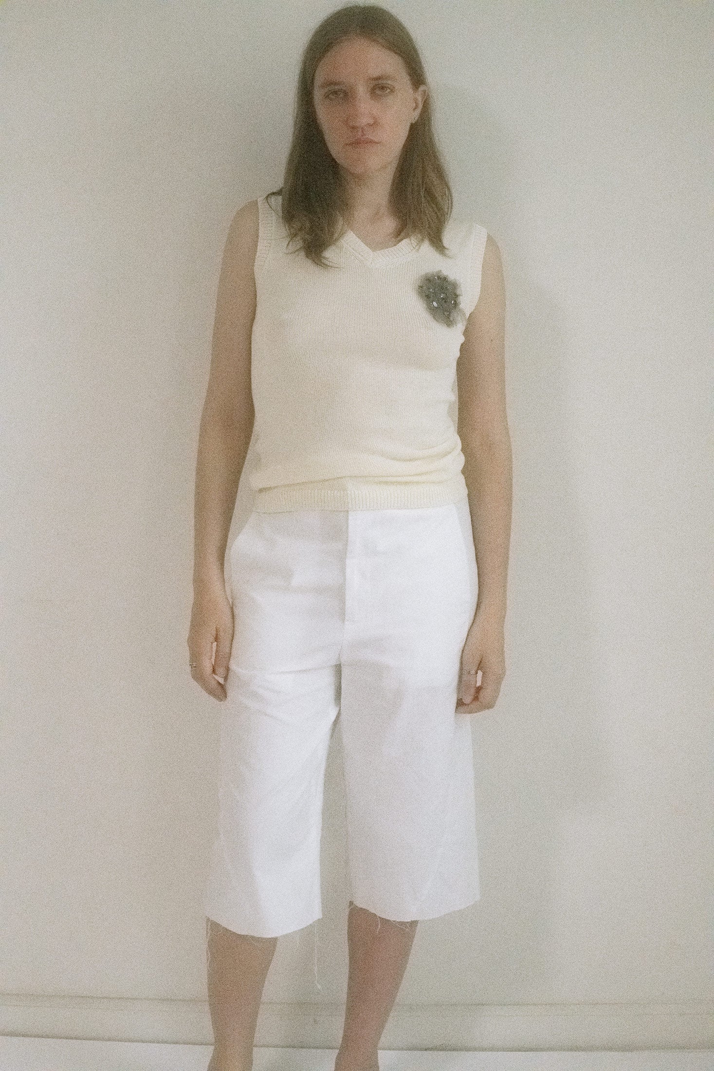 Crafted in a lightweight, thin knit that floats like a secret against the skin, its pristine white hue glows with understated elegance. 
