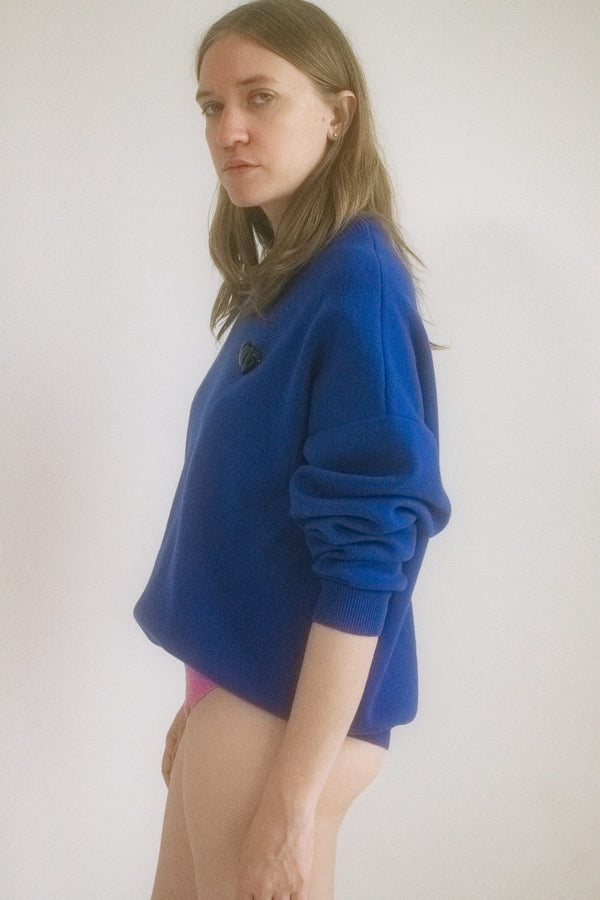 From Judy Turner’s downtown atelier: a cobalt blue crew neck sweater that doesn’t just walk into a room, it prowls. 