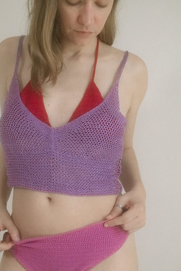 From Judy Turner’s New York atelier, a cropped crochet top that plays coy in lilac whispers. 