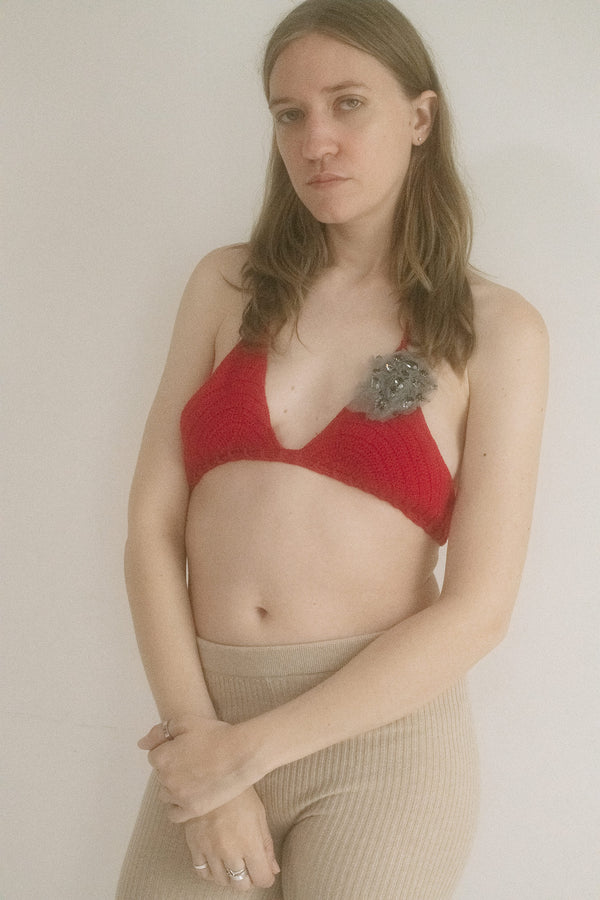 From the hands of Judy Turner and the heart of New York, a crochet bikini top in a come-hither red that doesn’t shy from attention. 