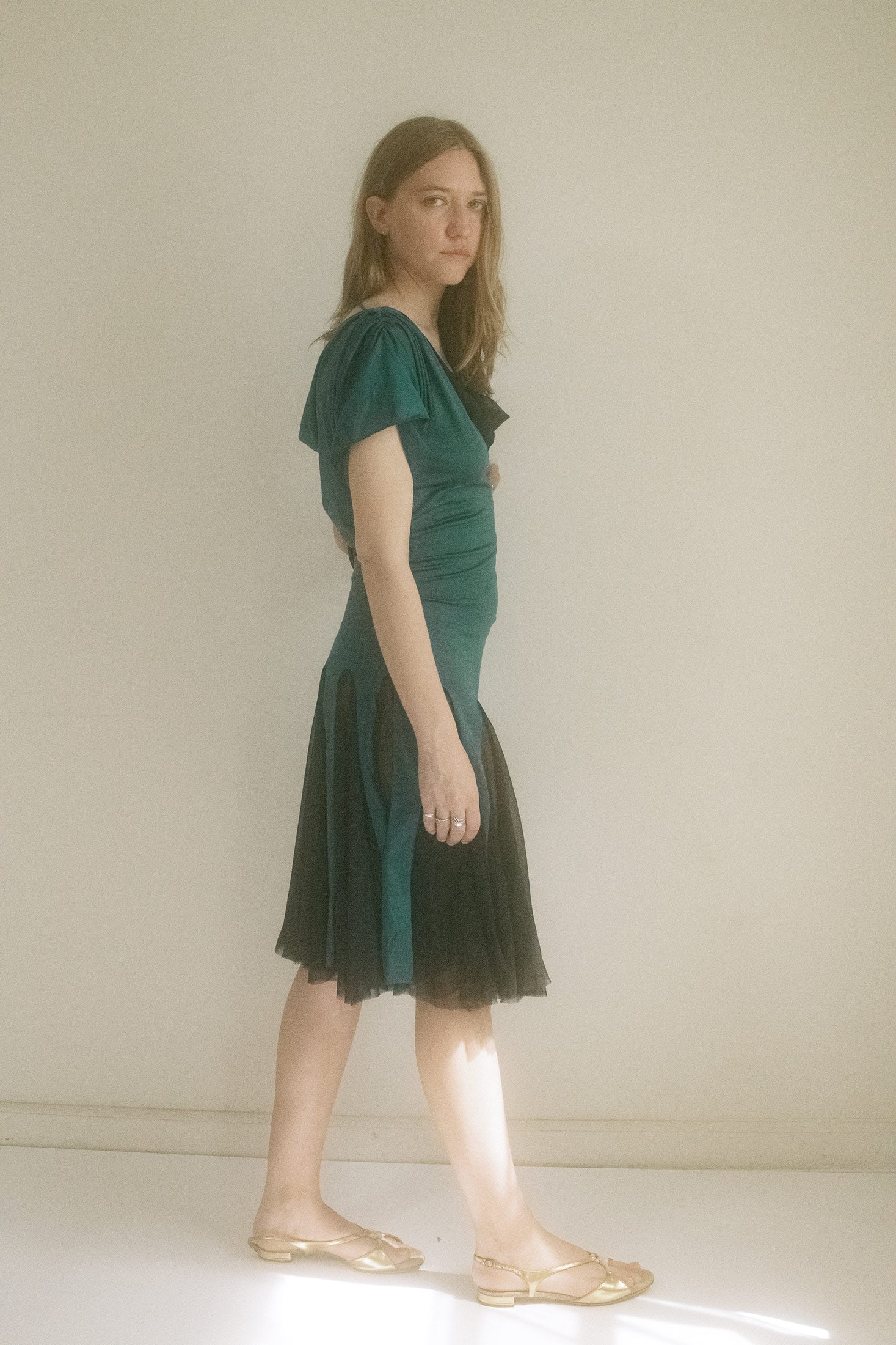 Teal with black accents, the cap sleeves barely graze the shoulder, while a plunging low back leaves just enough to the imagination. 
