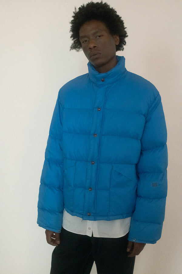 A vintage down puffer coat in a powder blue that feels both soft and striking.
