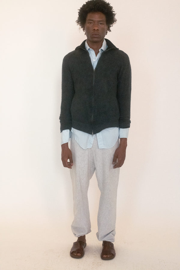 A vintage zip up sweater in deep charcoal, the kind that cloaks itself in understatement until you notice the details.
