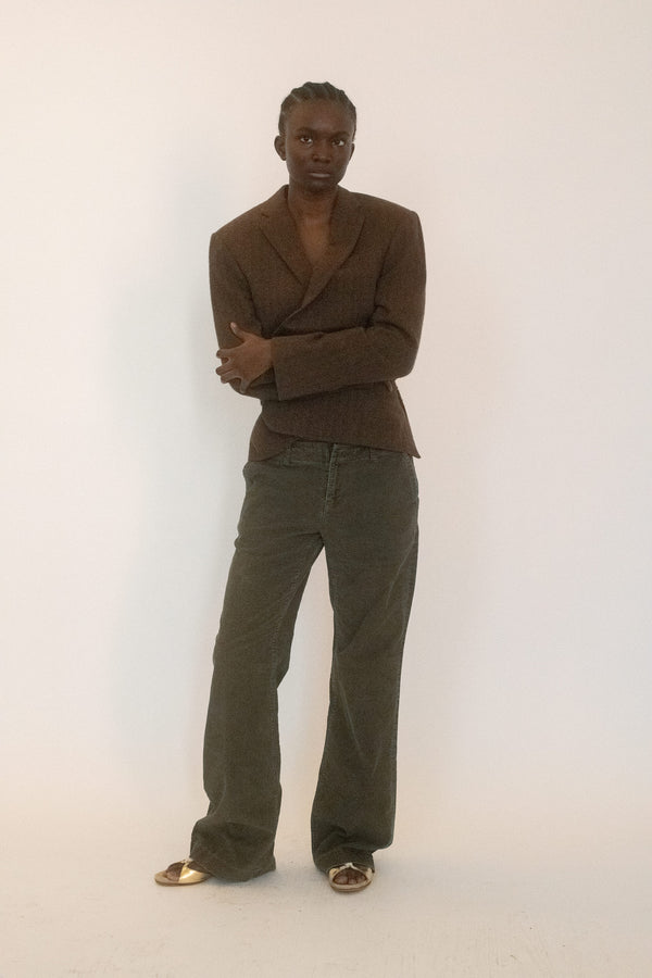 Banana Republic corduroy trousers, in a deep olive green that catches light like velvet. 
