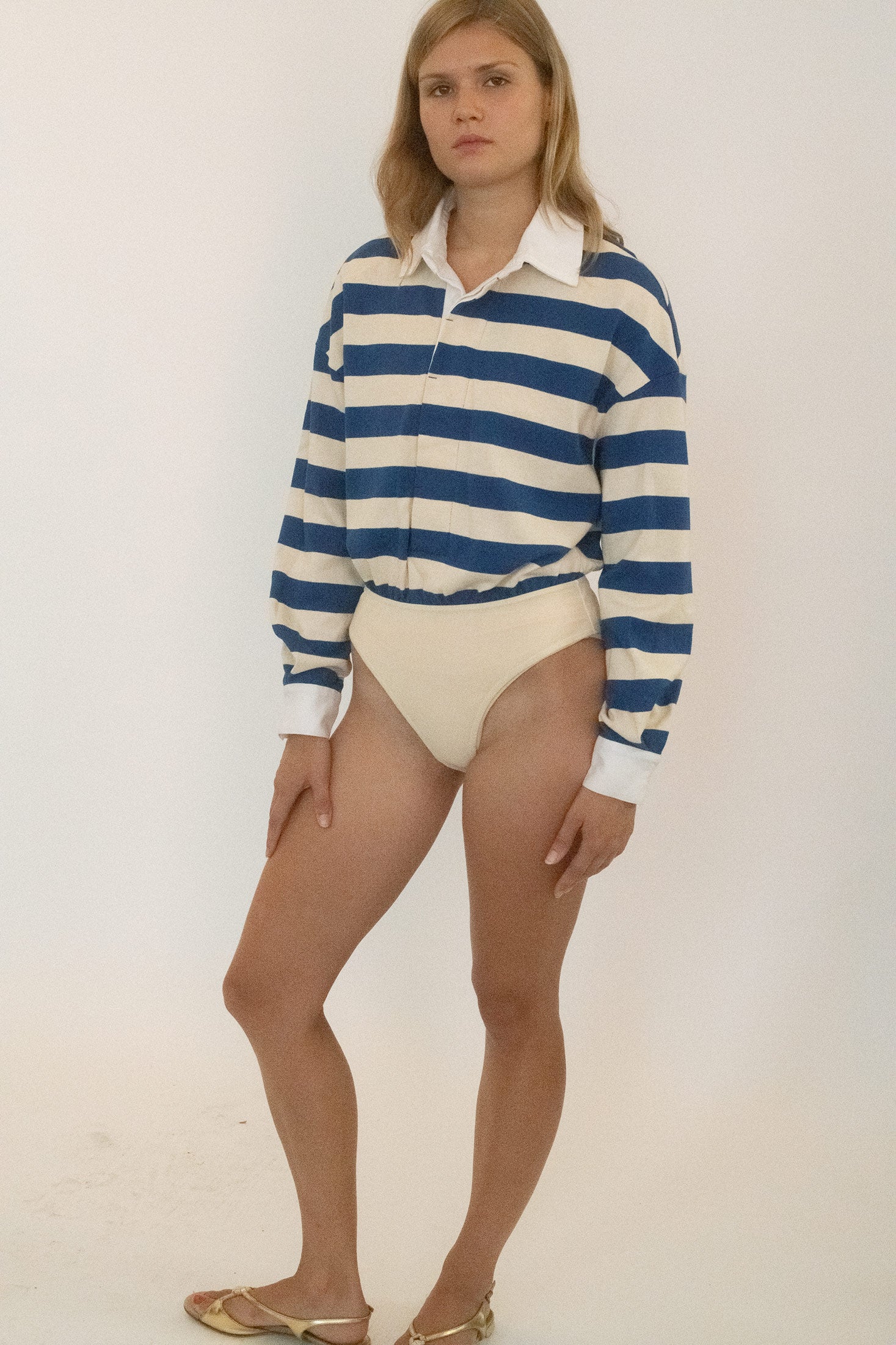 A long-sleeve rugby bodysuit from Stefania, cut with the precision of something both prim and subversive.
