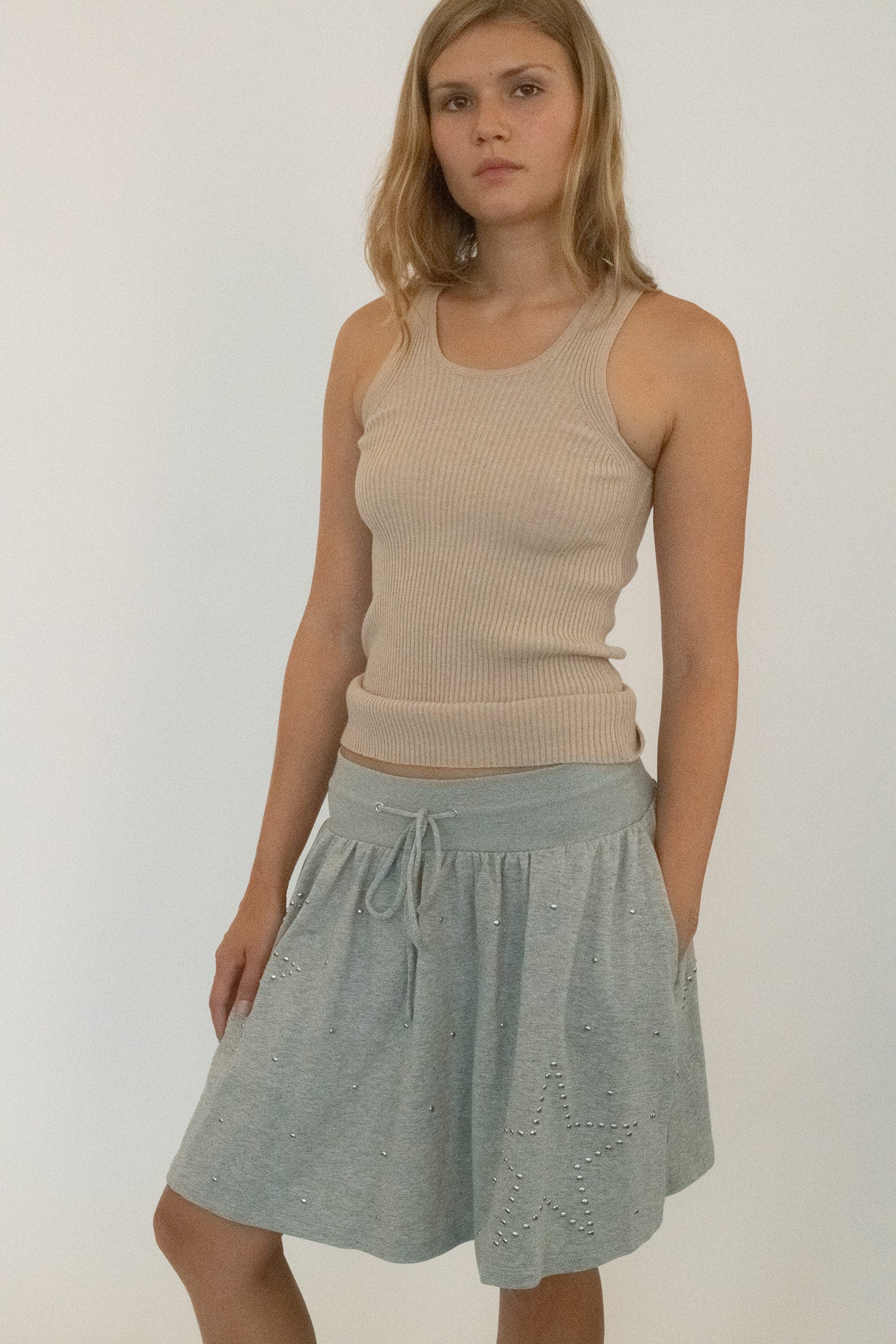 A piece that plays with softness and edge, designed to be worn like an offhand remark that lingers longer than expected.