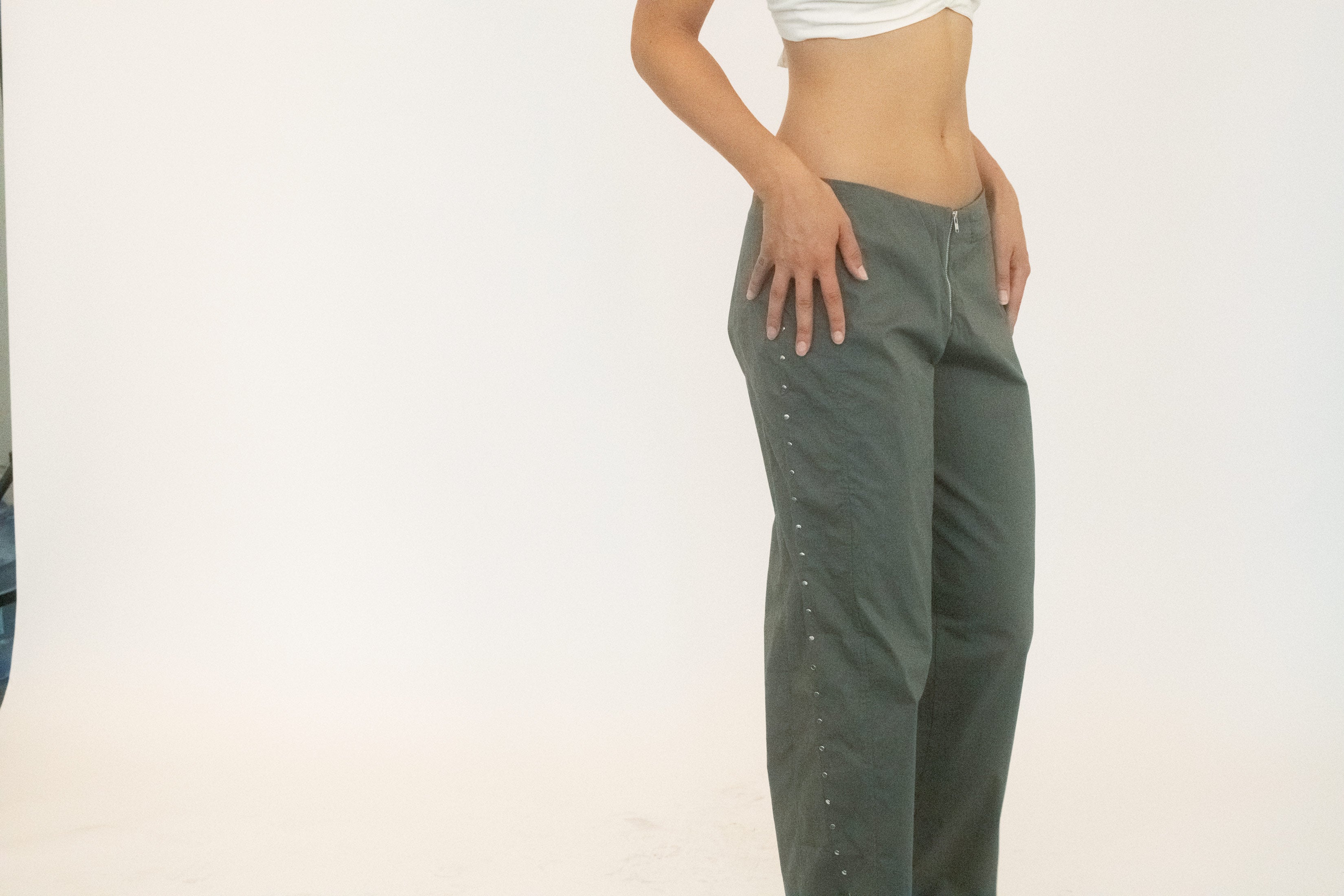 The front zip closure and pocket detailing keep the structure grounded, while hand-studded embellishments scatter across the surface like sparks.