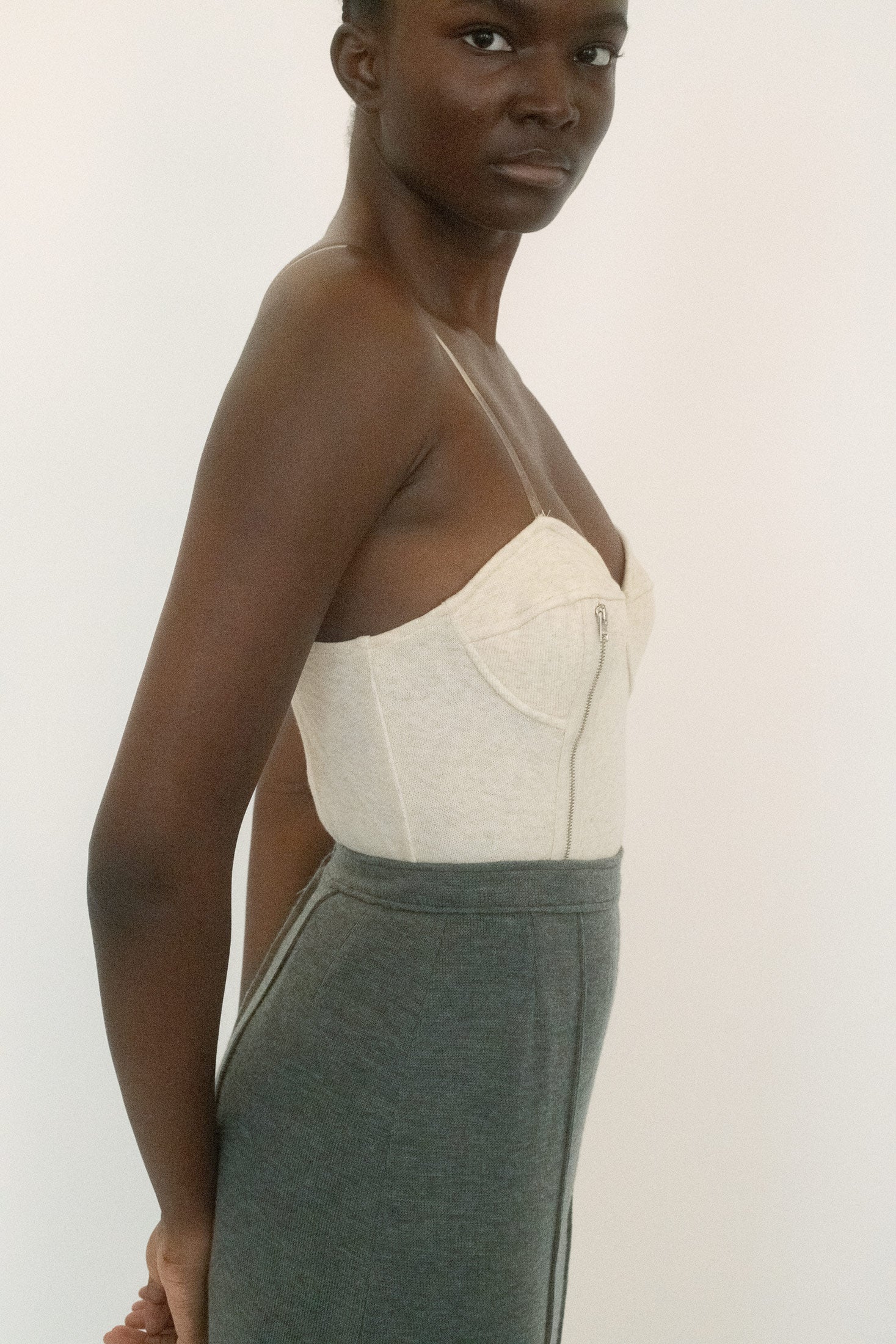 Clear adjustable straps barely register against the skin, leaving the focus on the structure. 