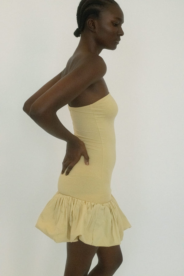 From Belle the Label, a strapless dress that plays with contrast, tight control giving way to sudden volume. 
