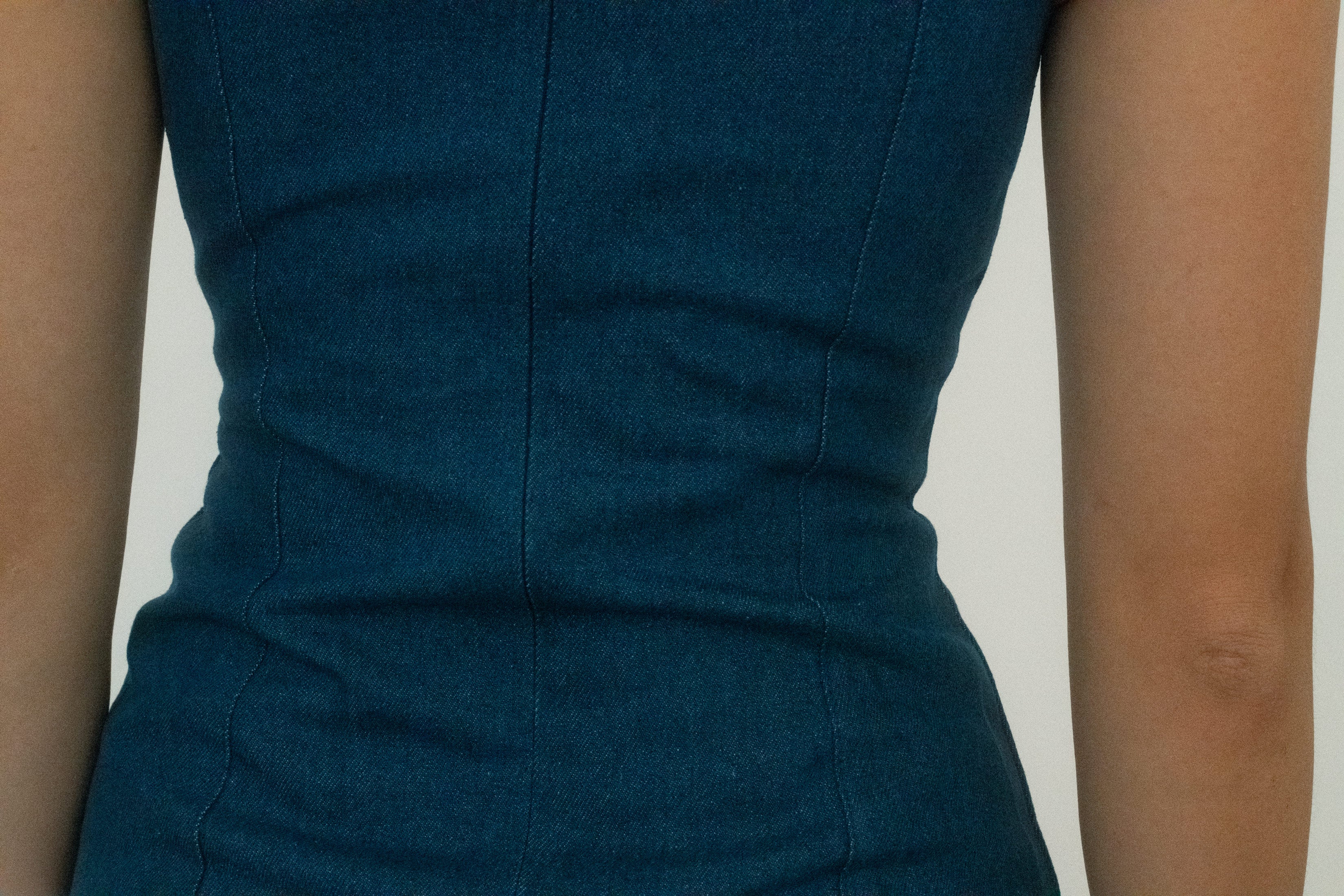The mix of fabrications, the denim’s weight against poplin’s ease, creates a tension that feels sculptural, cinematic, almost staged. 