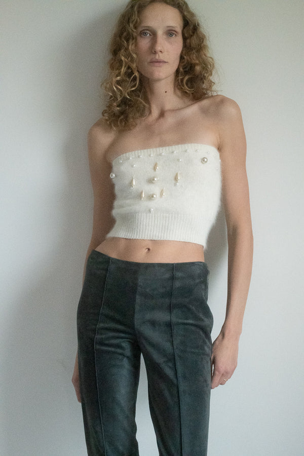 Step into the spotlight of style with Krizia's Vintage 1980s Knit Embellished Crop Top—a piece that transcends time and trends with its timeless allure. 