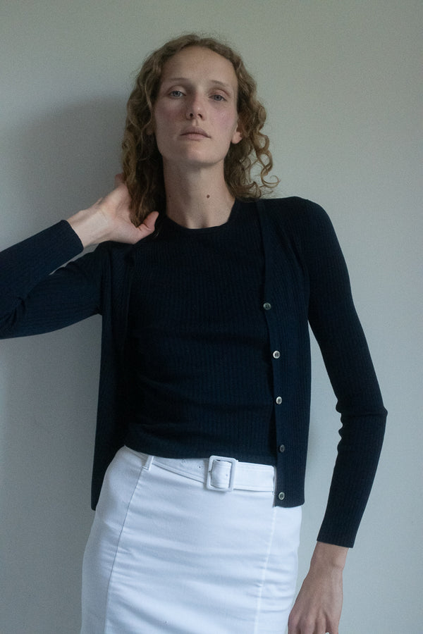 Announcing "the June", a fine knit ribbed cardigan that emerges as a thrilling enigma.