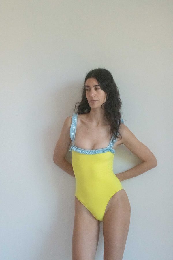 Step into the sunshine with our Yellow Jumper One Piece, a stunning creation by visionary swimwear designer Roxana Salehoun.