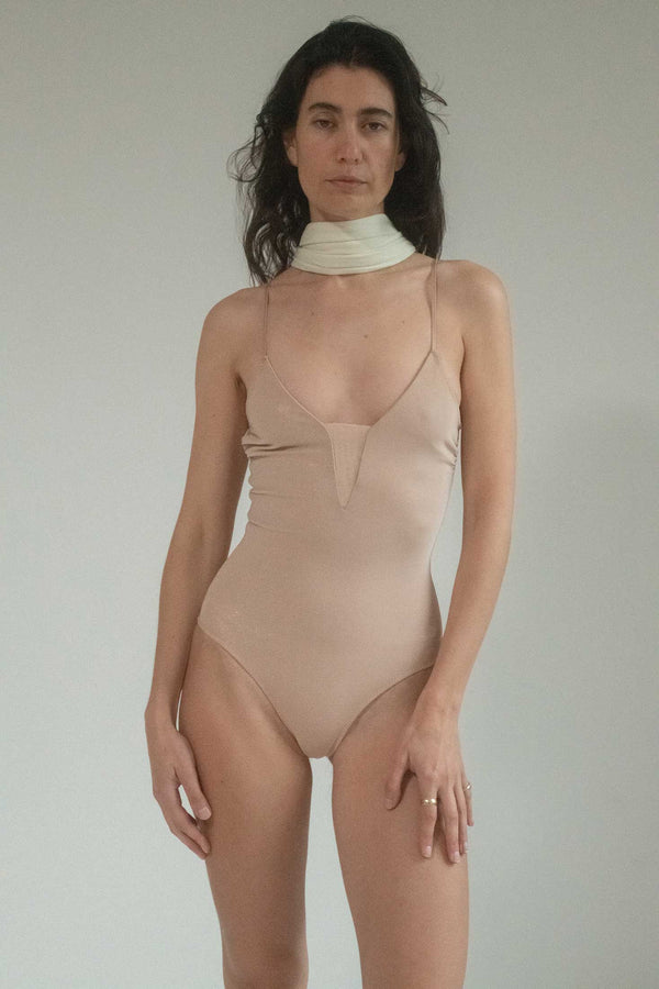 Step into a realm of timeless elegance and allure with the Roxana Salehoun Classic Scoop Back One Piece in a divine nude hue.