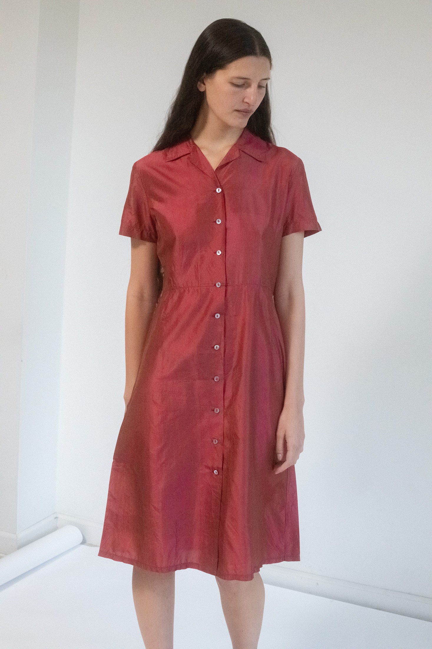 Step into the spotlight with the Dosa Shirtdress, a deep red silk marvel that embodies the essence of classic sophistication and mysterious allure.