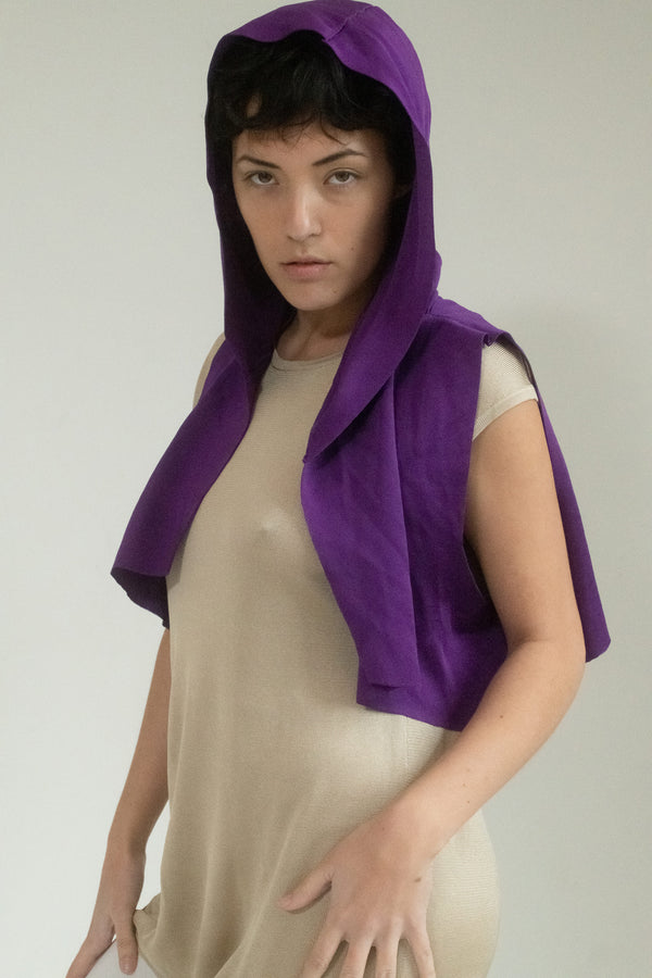 Judy Turner plays with contrast in this vibrant violet shrug, where casual form meets an undercurrent of sophistication. 