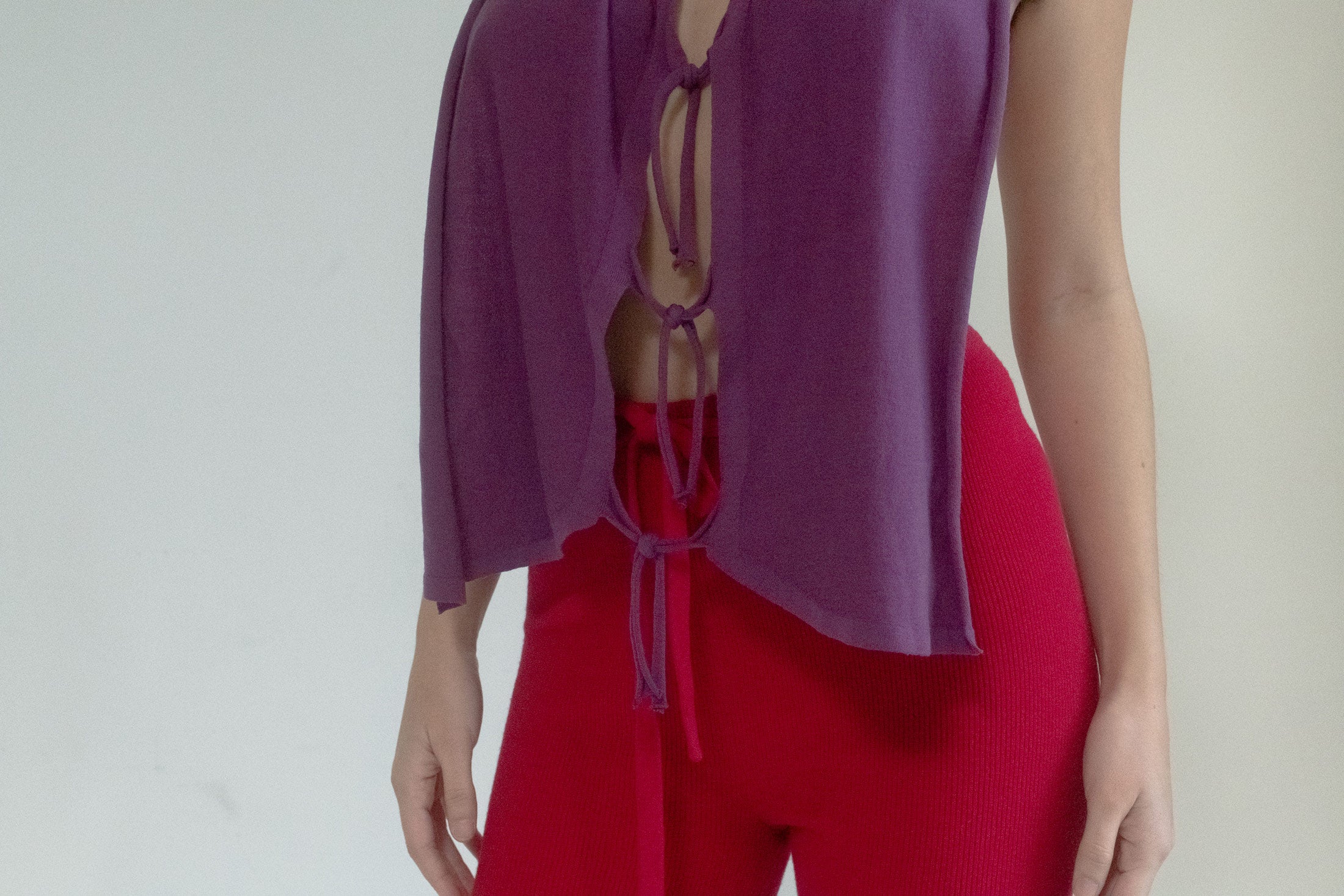 This top invites the unexpected with a completely open back. Can be worn layered or belted to hold it in place. 