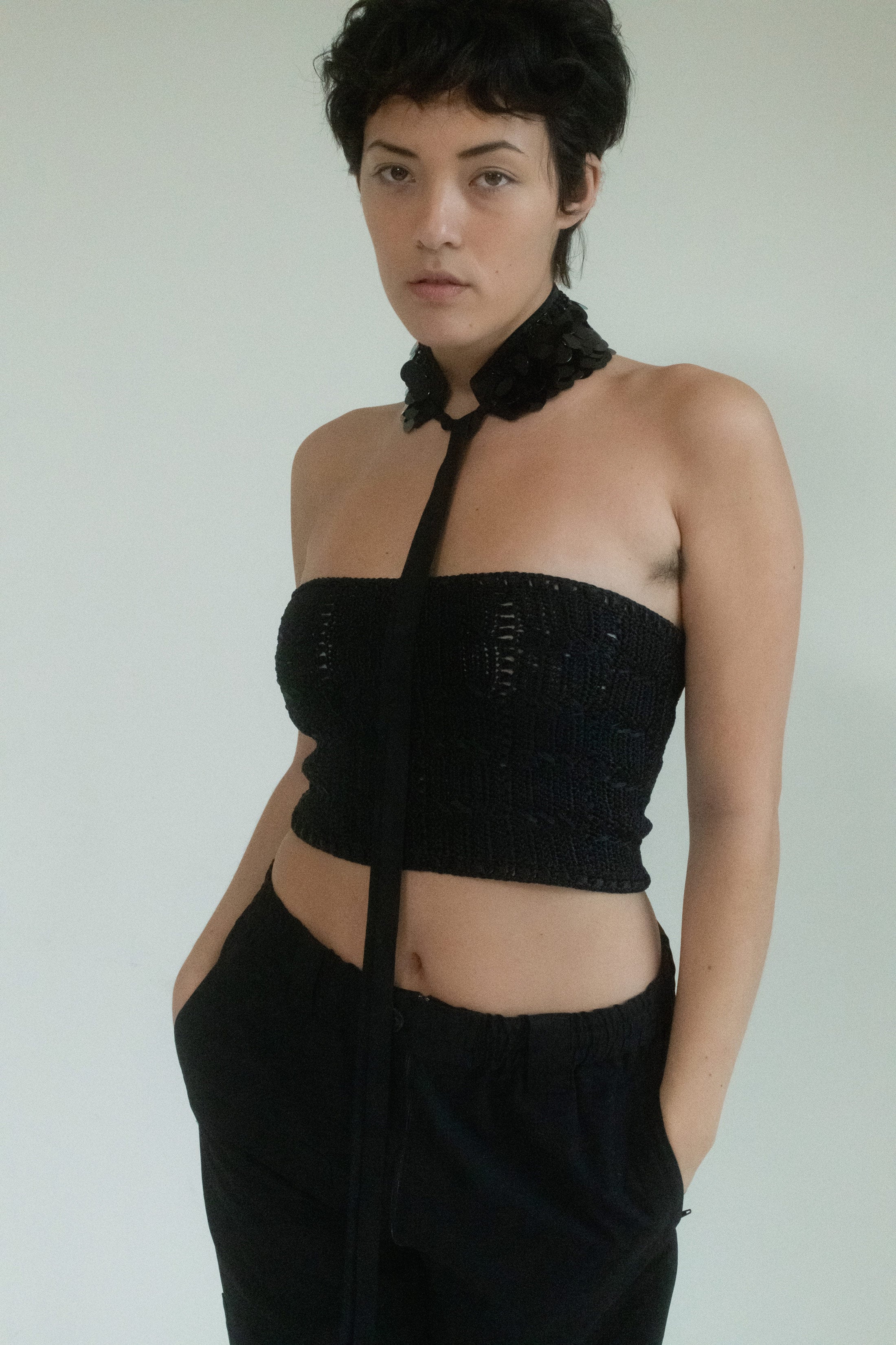 In the dim haze of a city after dark, Judy Turner delivers a textured knit tube top that doesn’t just sit on your skin—it clings with purpose. 