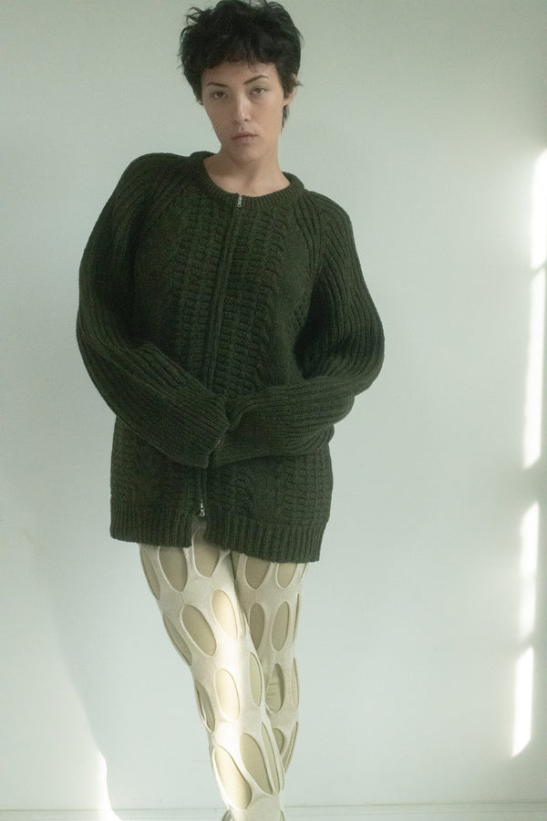 In Judy Turner’s hands, this classic zip-up knit becomes a study in quiet texture and form. 